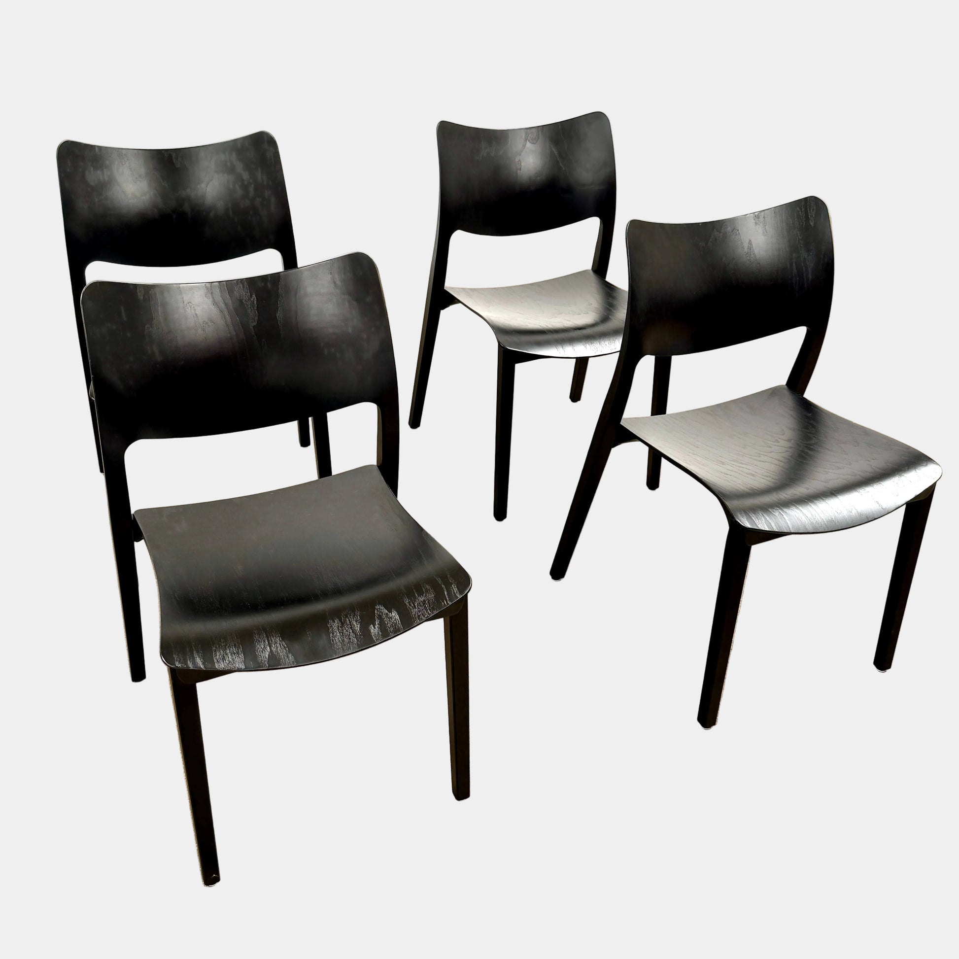 A set of four Stua LaClassica Bastua Dining Chairs by Stua, featuring solid wood with visible grain and gently curved backs and seats, are shown in two rows on a plain white background.