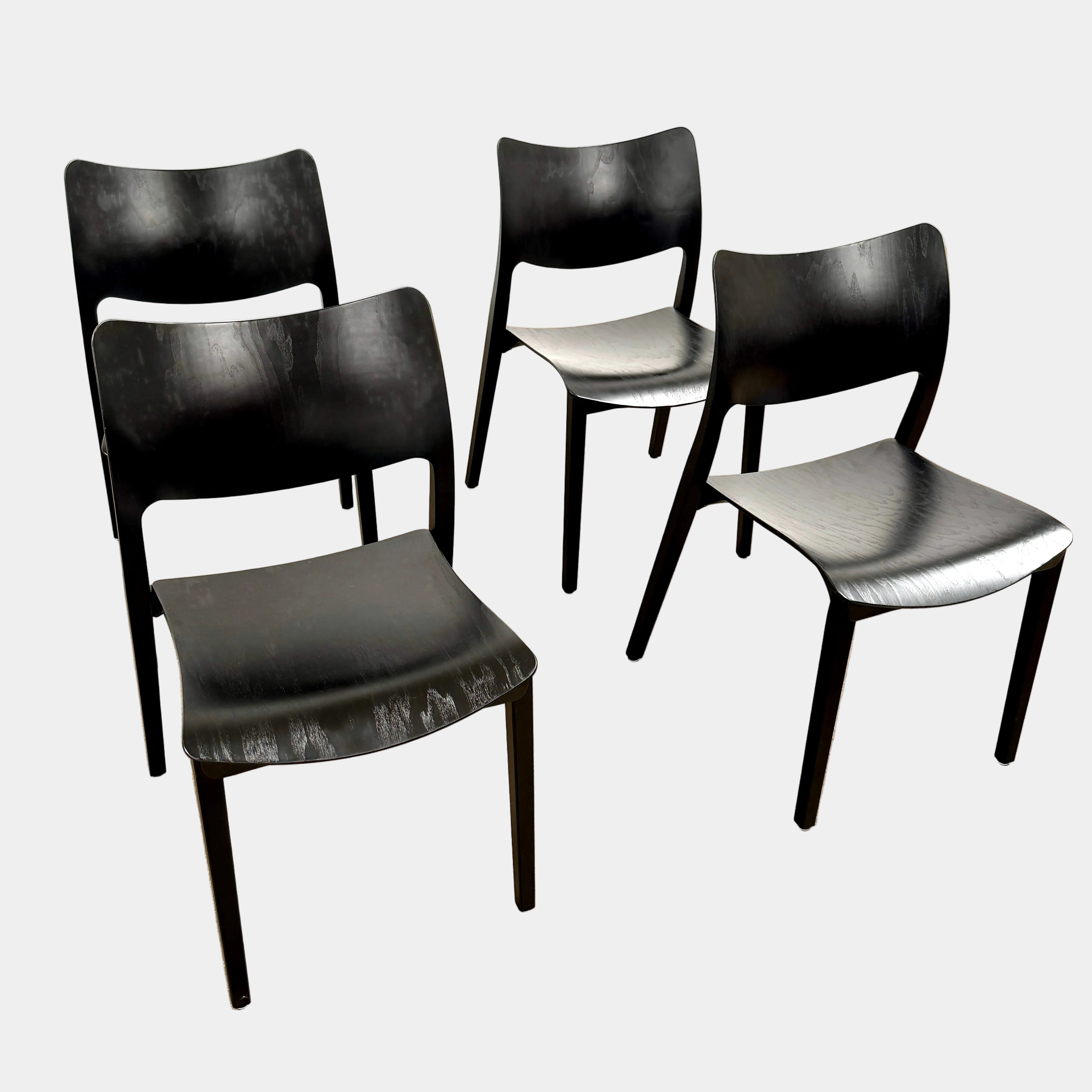 A set of four Stua LaClassica Bastua Dining Chairs by Stua, featuring solid wood with visible grain and gently curved backs and seats, are shown in two rows on a plain white background.