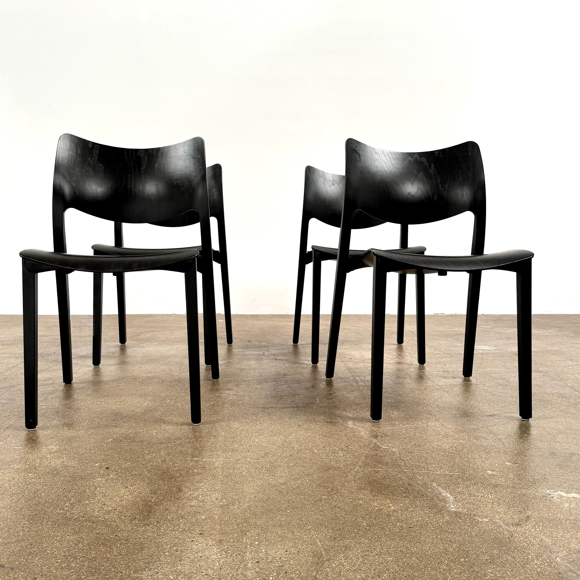 A set of four Stua LaClassica Bastua Dining Chairs by Stua, featuring solid wood with visible grain and gently curved backs and seats, are shown in two rows on a plain white background.