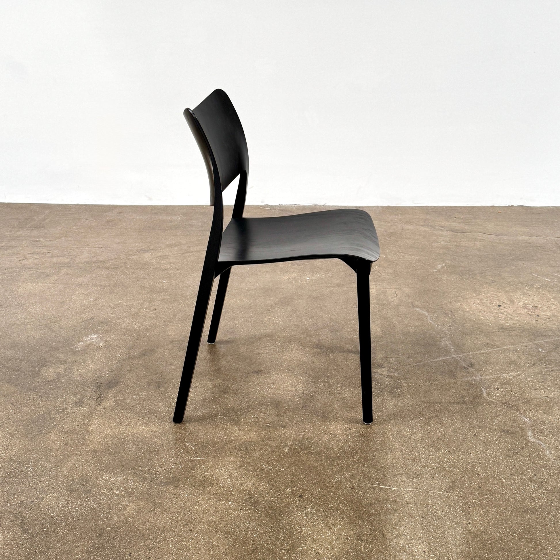 A set of four Stua LaClassica Bastua Dining Chairs by Stua, featuring solid wood with visible grain and gently curved backs and seats, are shown in two rows on a plain white background.