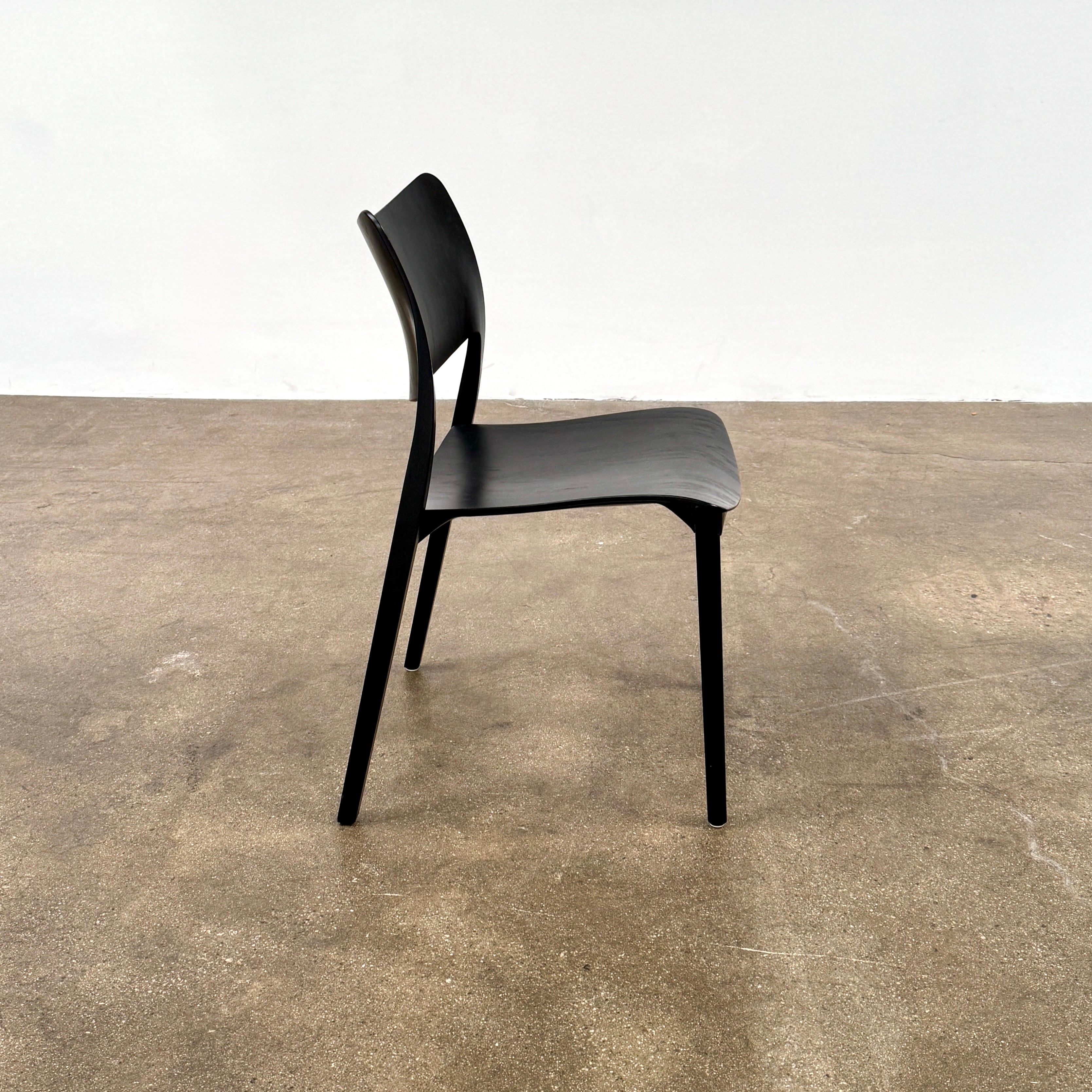 A set of four Stua LaClassica Bastua Dining Chairs by Stua, featuring solid wood with visible grain and gently curved backs and seats, are shown in two rows on a plain white background.