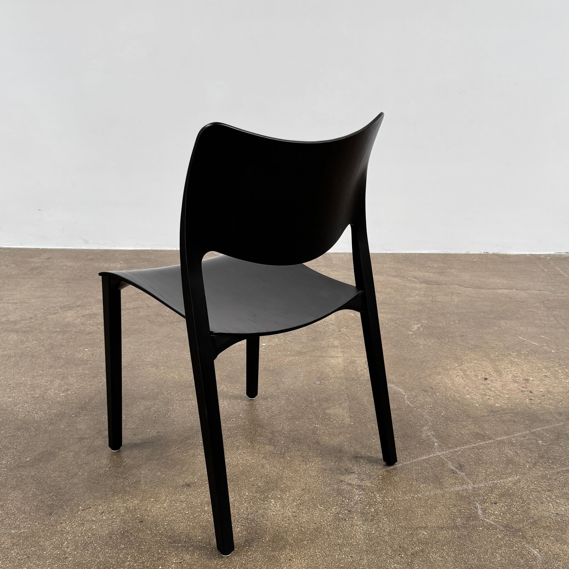 A set of four Stua LaClassica Bastua Dining Chairs by Stua, featuring solid wood with visible grain and gently curved backs and seats, are shown in two rows on a plain white background.