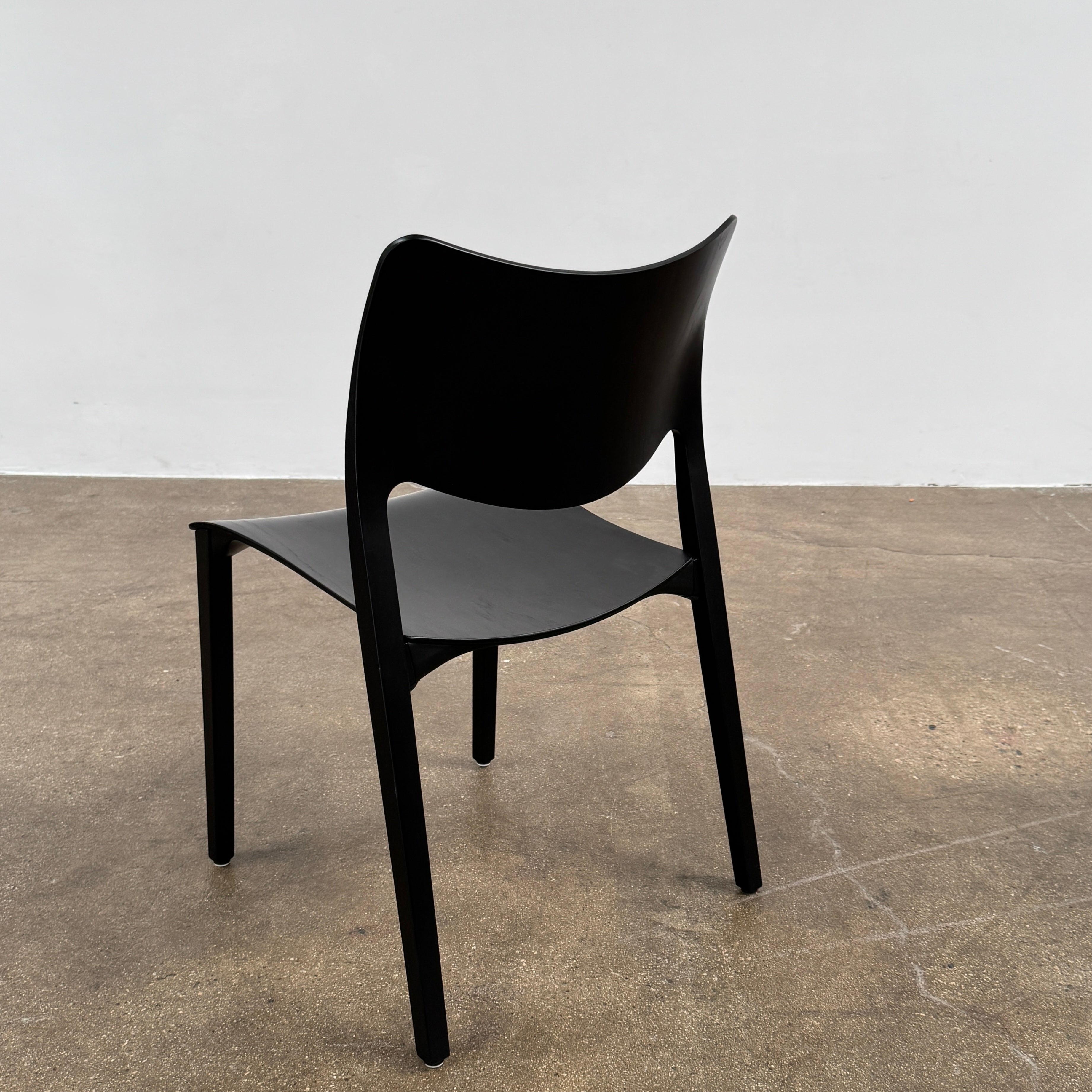 A set of four Stua LaClassica Bastua Dining Chairs by Stua, featuring solid wood with visible grain and gently curved backs and seats, are shown in two rows on a plain white background.