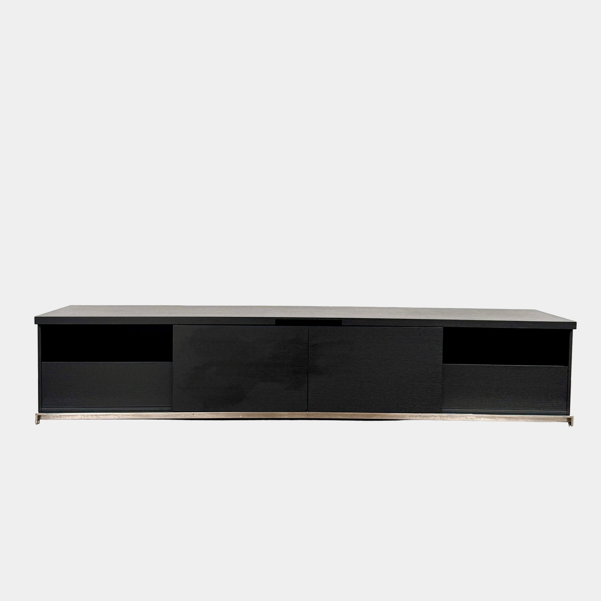 The Maxalto Mida Console by Maxalto is a modern black sideboard TV stand with three closed cabinets and two open shelves, shown on a concrete floor against a plain white background.