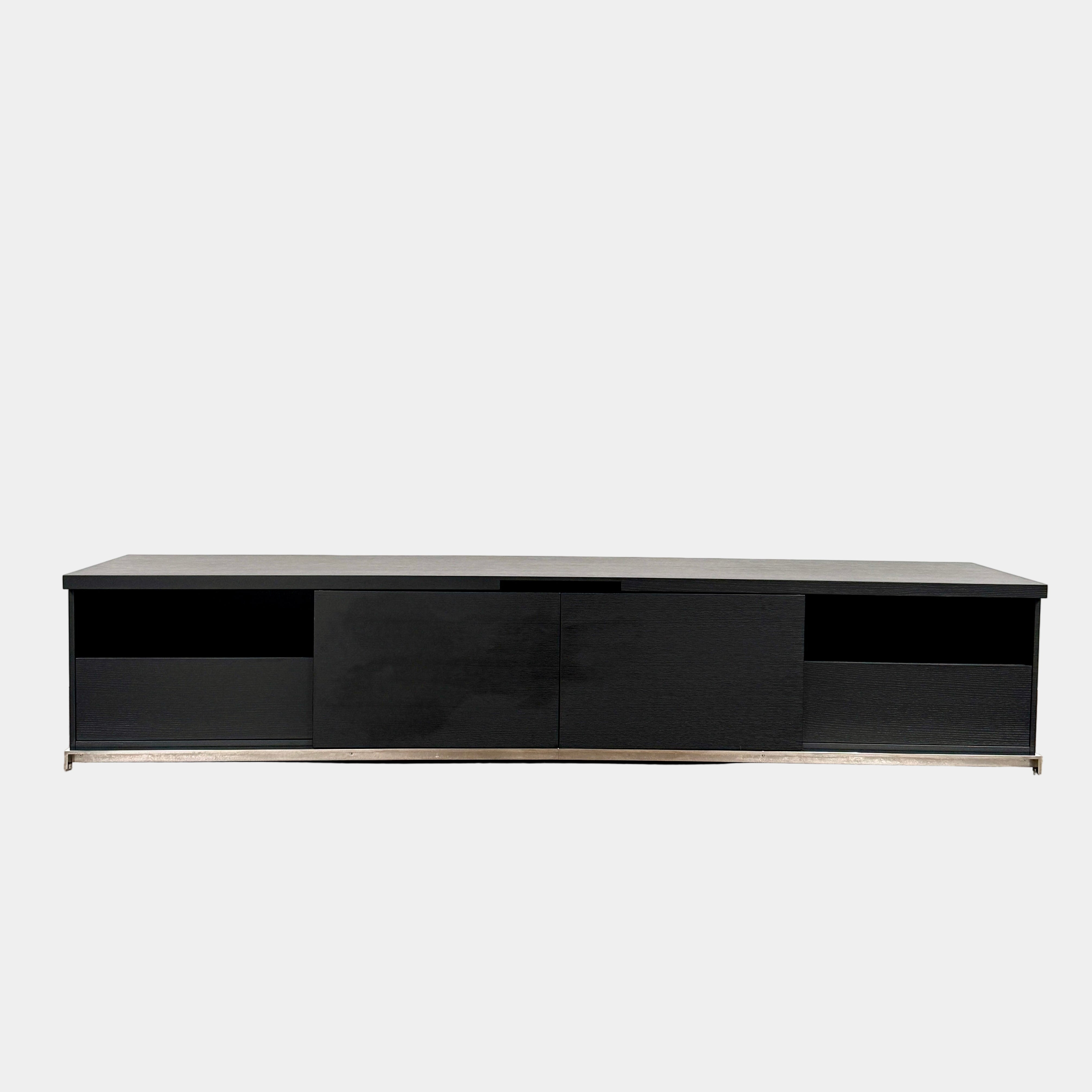 The Maxalto Mida Console by Maxalto is a modern black sideboard TV stand with three closed cabinets and two open shelves, shown on a concrete floor against a plain white background.