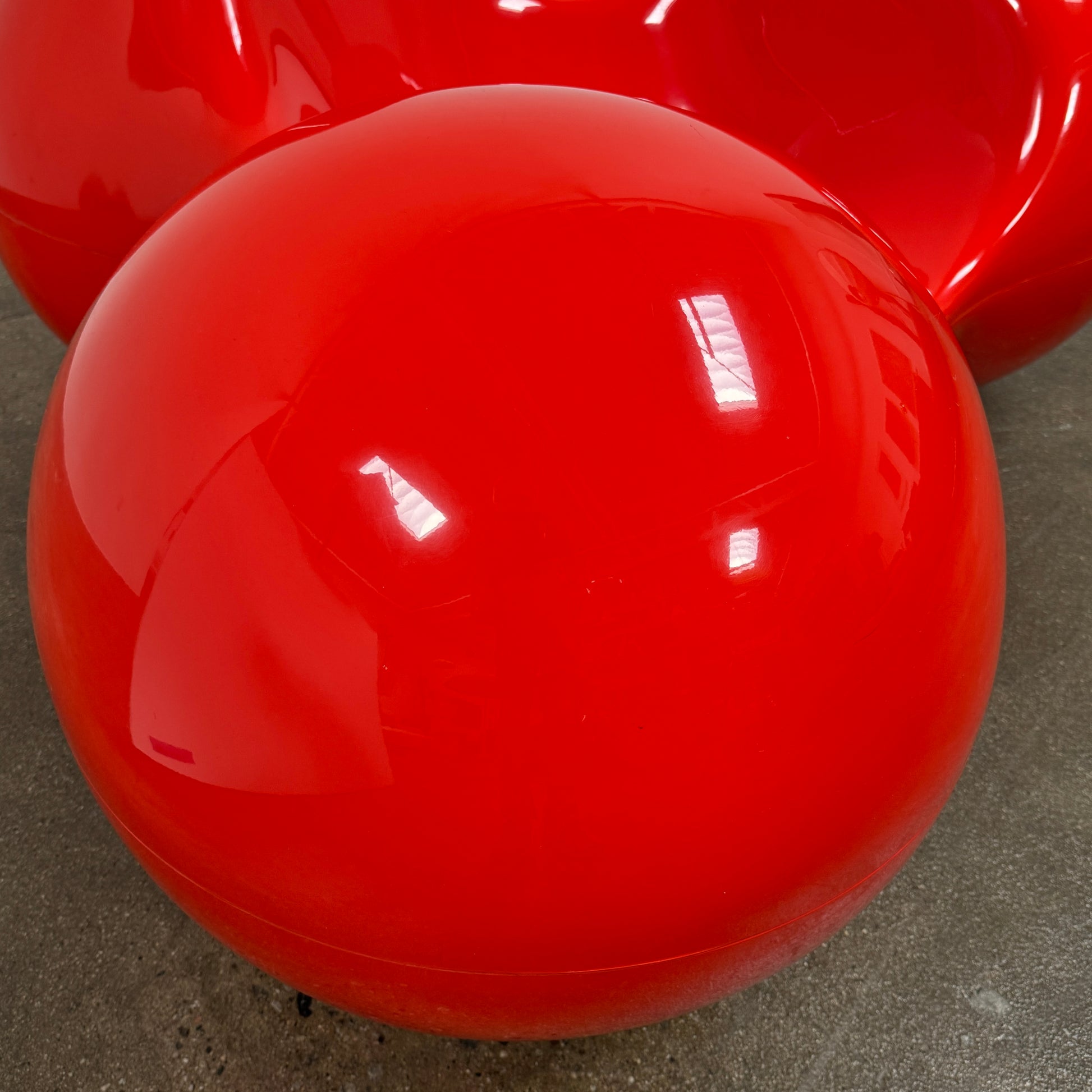 The Eero Aarnio Originals Tomato Chair by Eero Aarnio Originals is a glossy red modern plastic chair with three rounded, connected sections, inspired by the original design and shown against a plain white background.