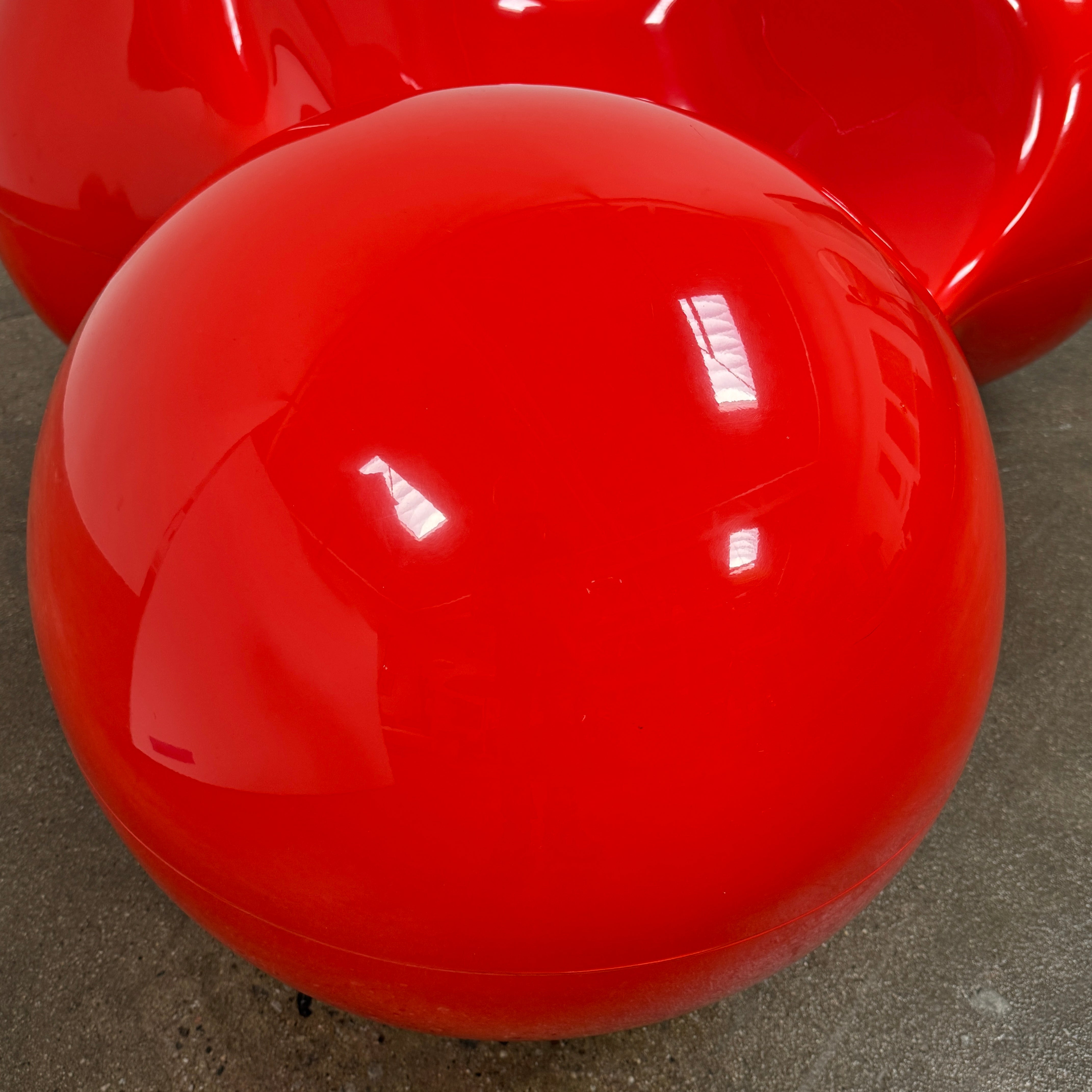 The Eero Aarnio Originals Tomato Chair by Eero Aarnio Originals is a glossy red modern plastic chair with three rounded, connected sections, inspired by the original design and shown against a plain white background.