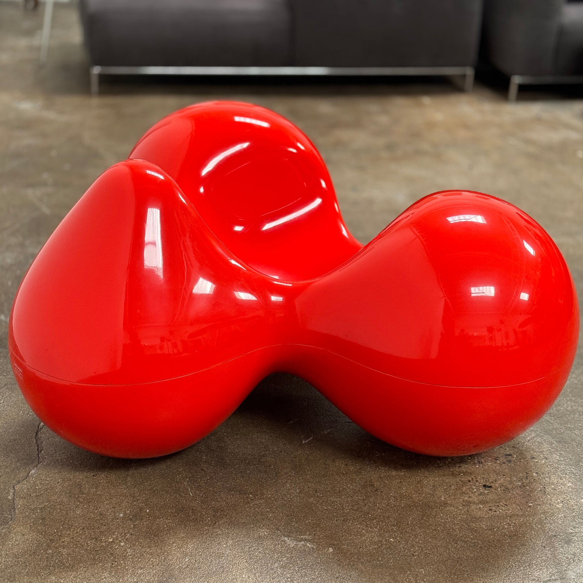 The Eero Aarnio Originals Tomato Chair by Eero Aarnio Originals is a glossy red modern plastic chair with three rounded, connected sections, inspired by the original design and shown against a plain white background.
