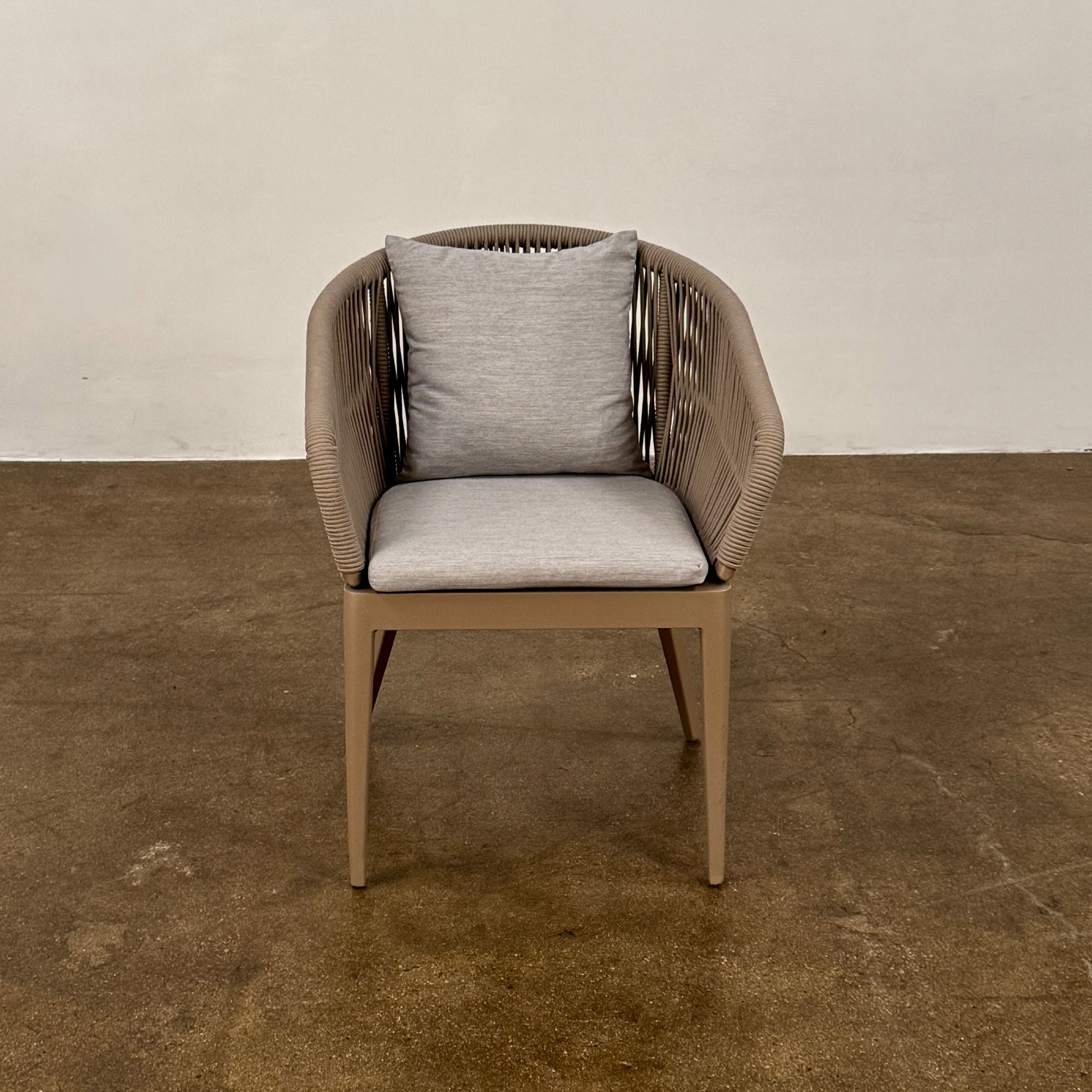 Six Harbour Hamilton Outdoor Dining Chairs by Harbour, featuring a beige woven design with light cushions, are arranged in two rows of three on a plain light background.