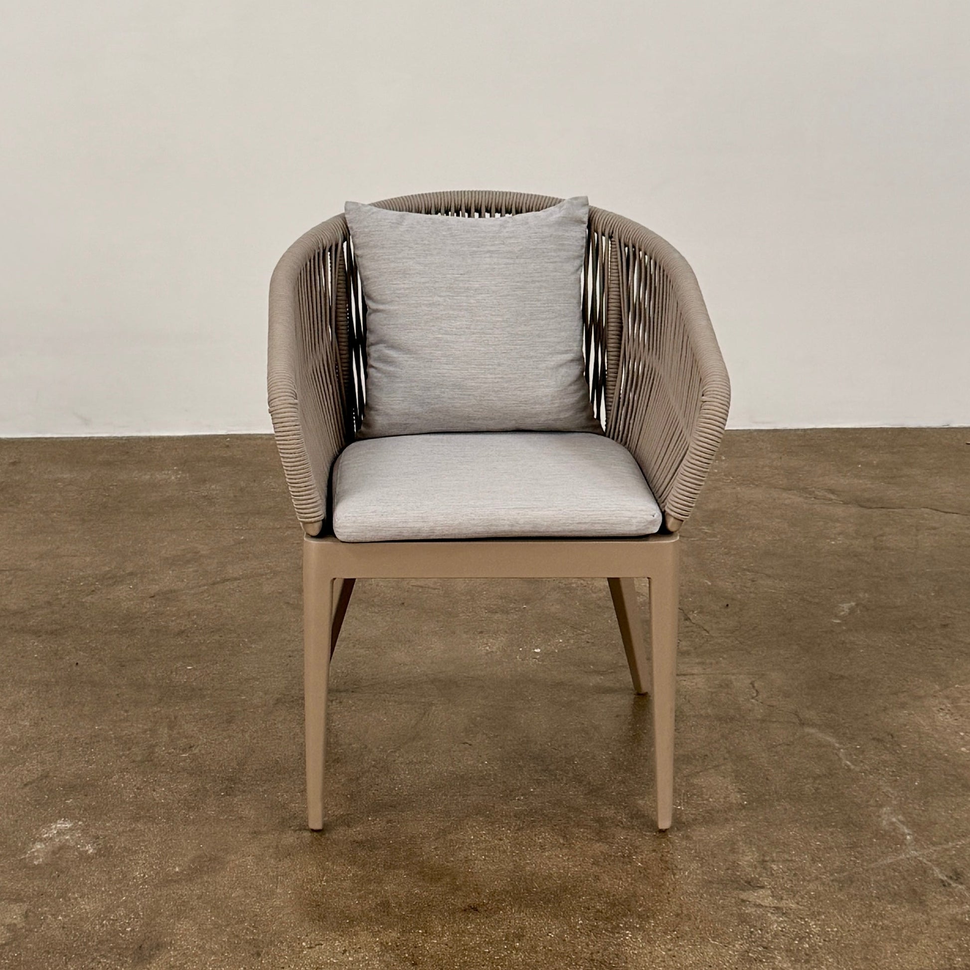 Six Harbour Hamilton Outdoor Dining Chairs by Harbour, featuring a beige woven design with light cushions, are arranged in two rows of three on a plain light background.