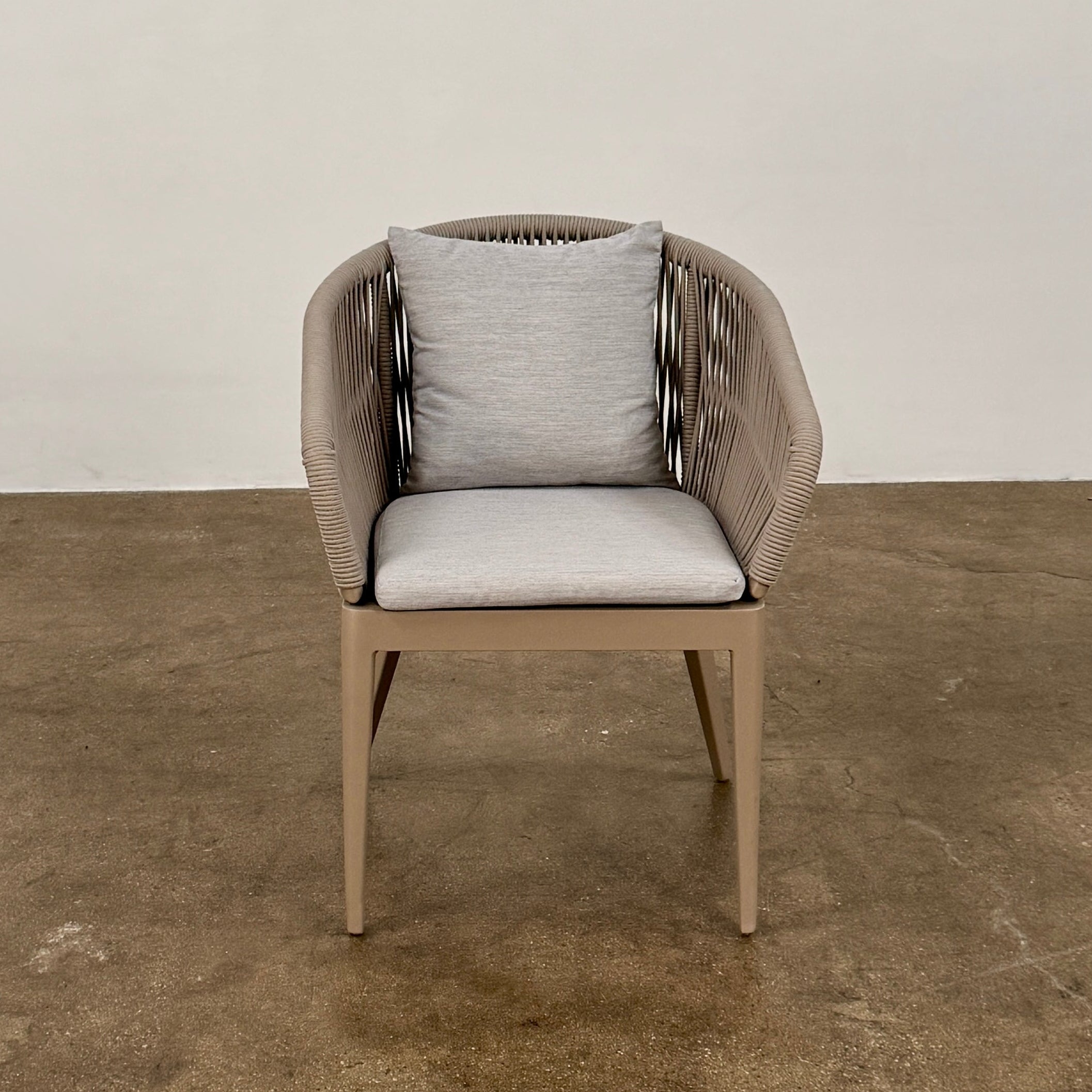 Six Harbour Hamilton Outdoor Dining Chairs by Harbour, featuring a beige woven design with light cushions, are arranged in two rows of three on a plain light background.