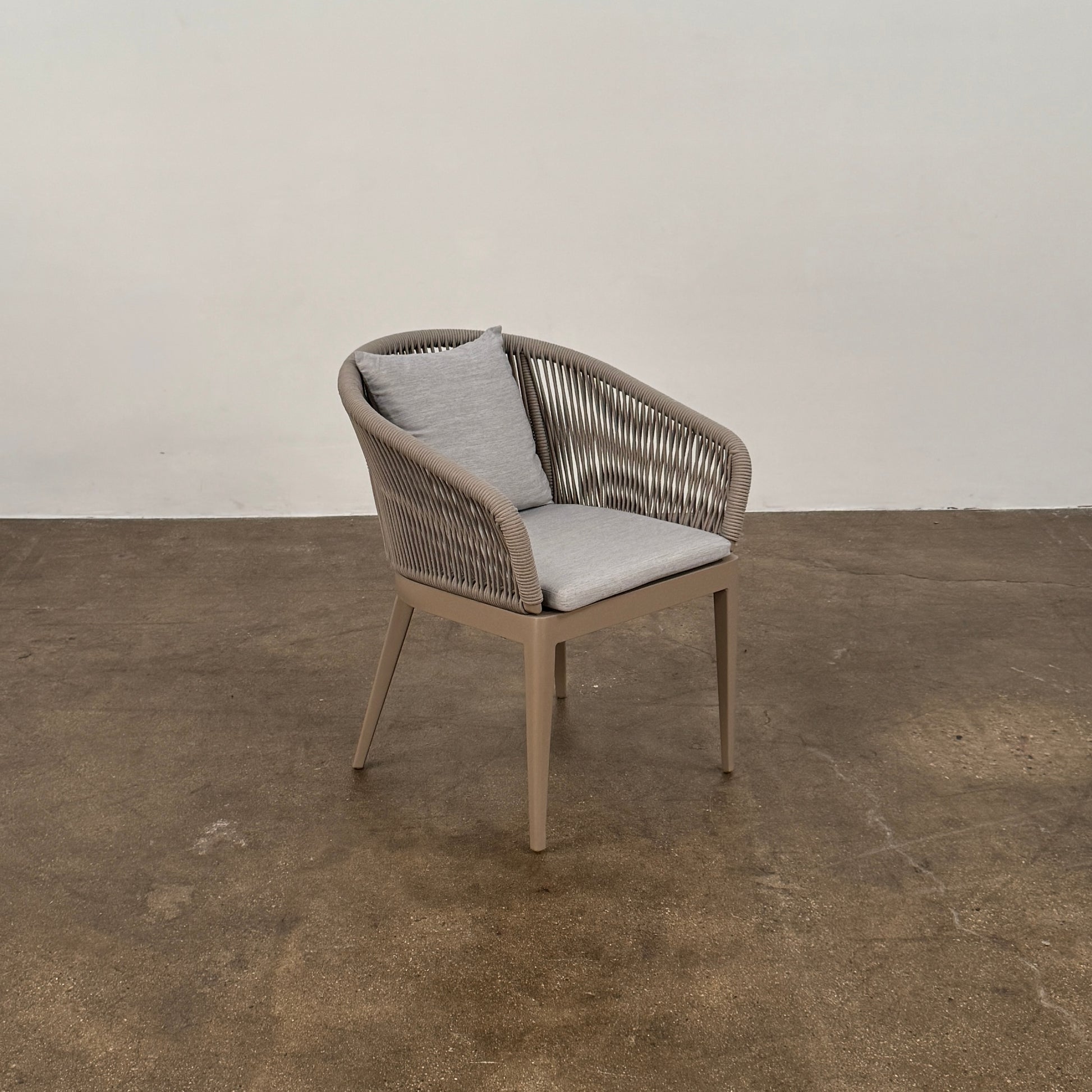 Six Harbour Hamilton Outdoor Dining Chairs by Harbour, featuring a beige woven design with light cushions, are arranged in two rows of three on a plain light background.