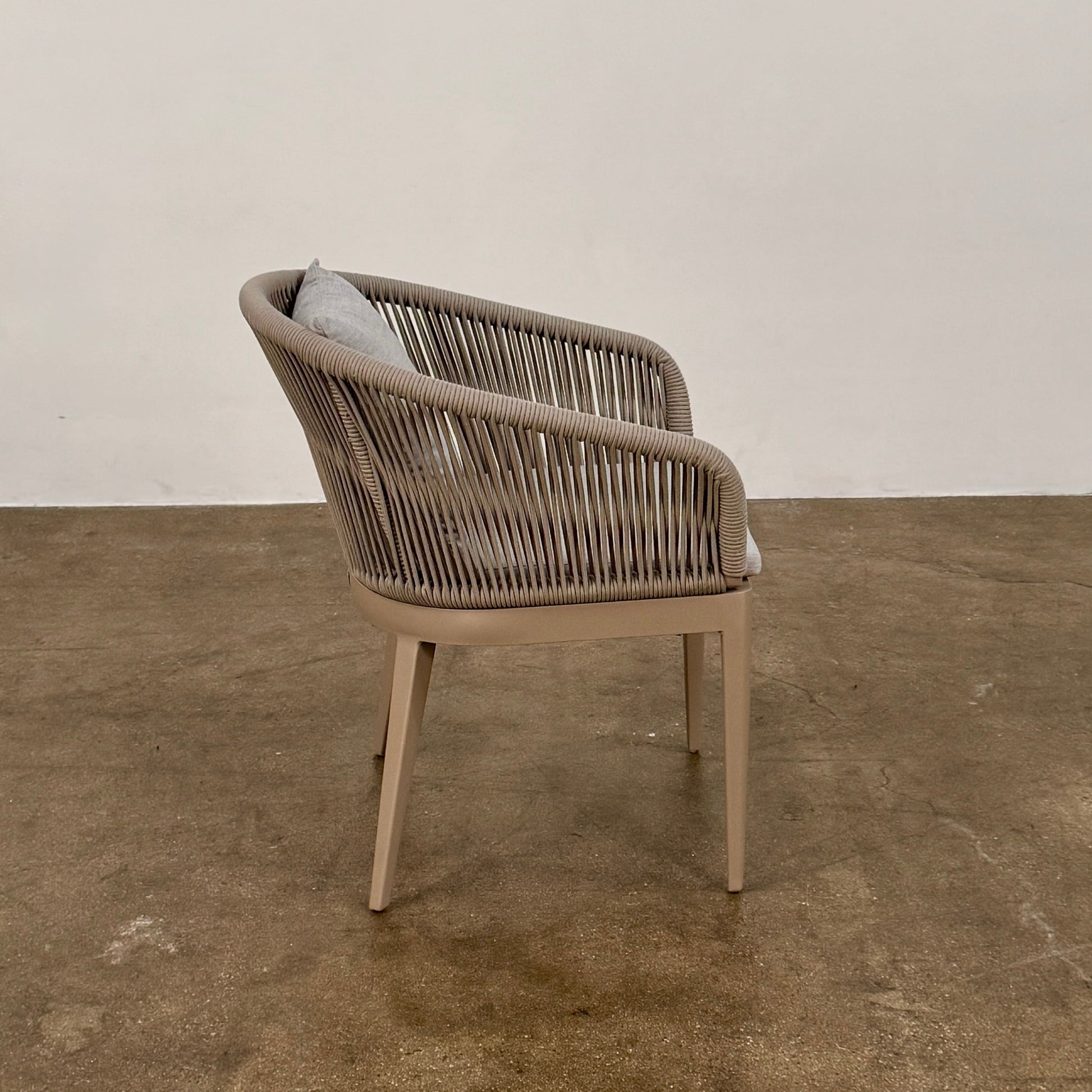 Six Harbour Hamilton Outdoor Dining Chairs by Harbour, featuring a beige woven design with light cushions, are arranged in two rows of three on a plain light background.