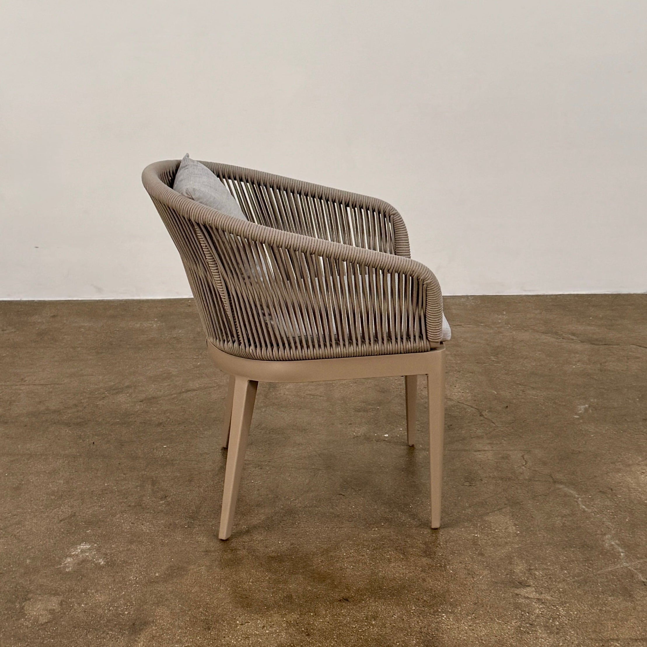 Six Harbour Hamilton Outdoor Dining Chairs by Harbour, featuring a beige woven design with light cushions, are arranged in two rows of three on a plain light background.