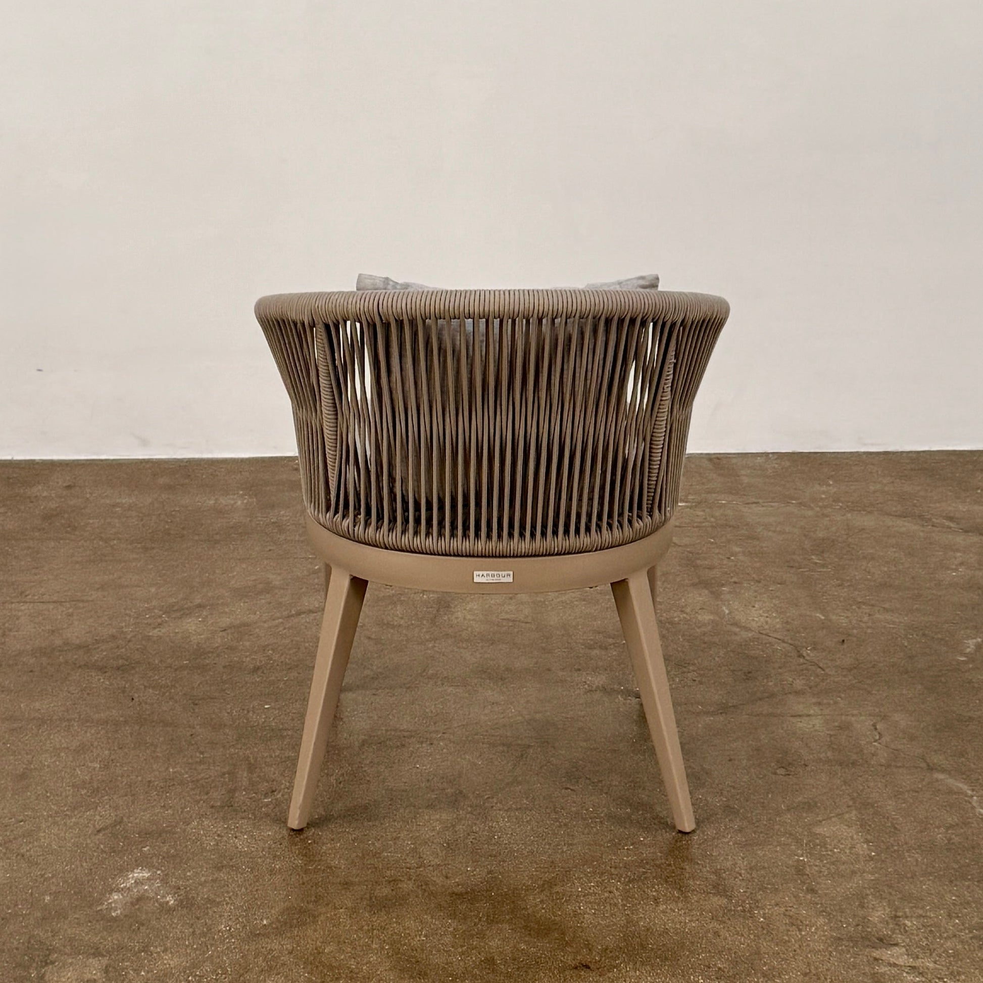 Six Harbour Hamilton Outdoor Dining Chairs by Harbour, featuring a beige woven design with light cushions, are arranged in two rows of three on a plain light background.