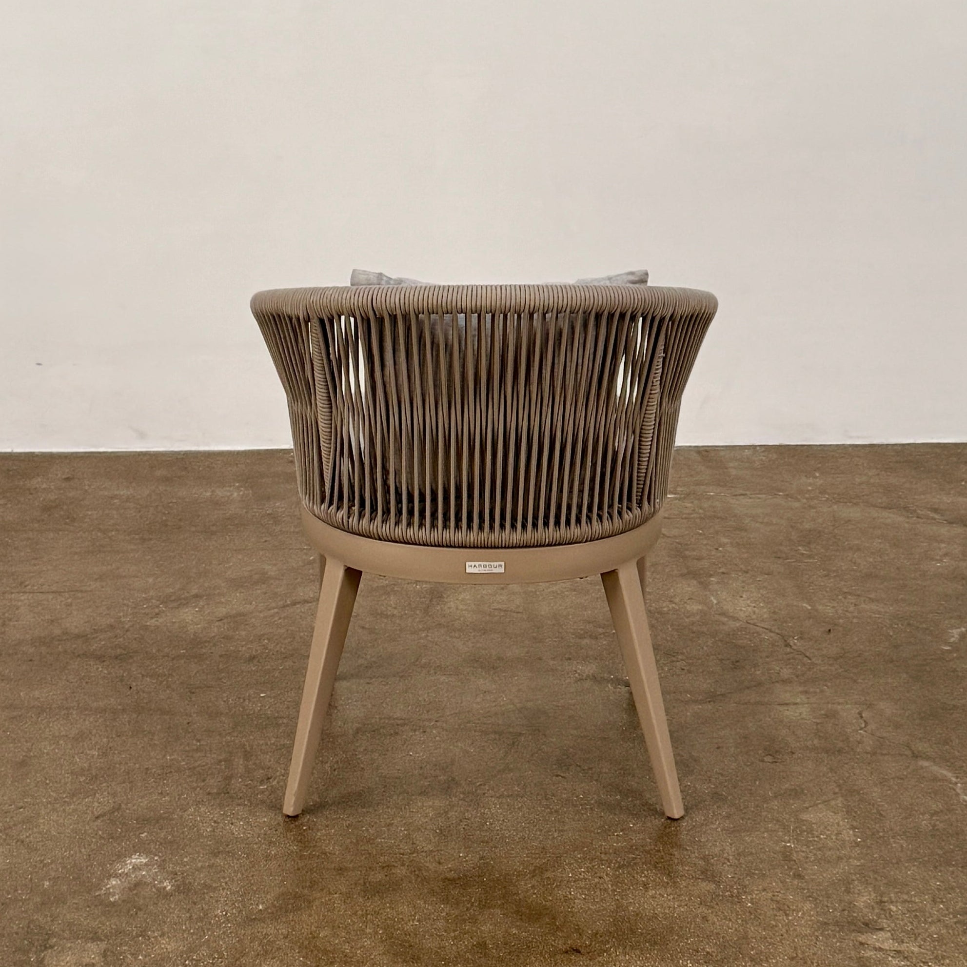 Six Harbour Hamilton Outdoor Dining Chairs by Harbour, featuring a beige woven design with light cushions, are arranged in two rows of three on a plain light background.