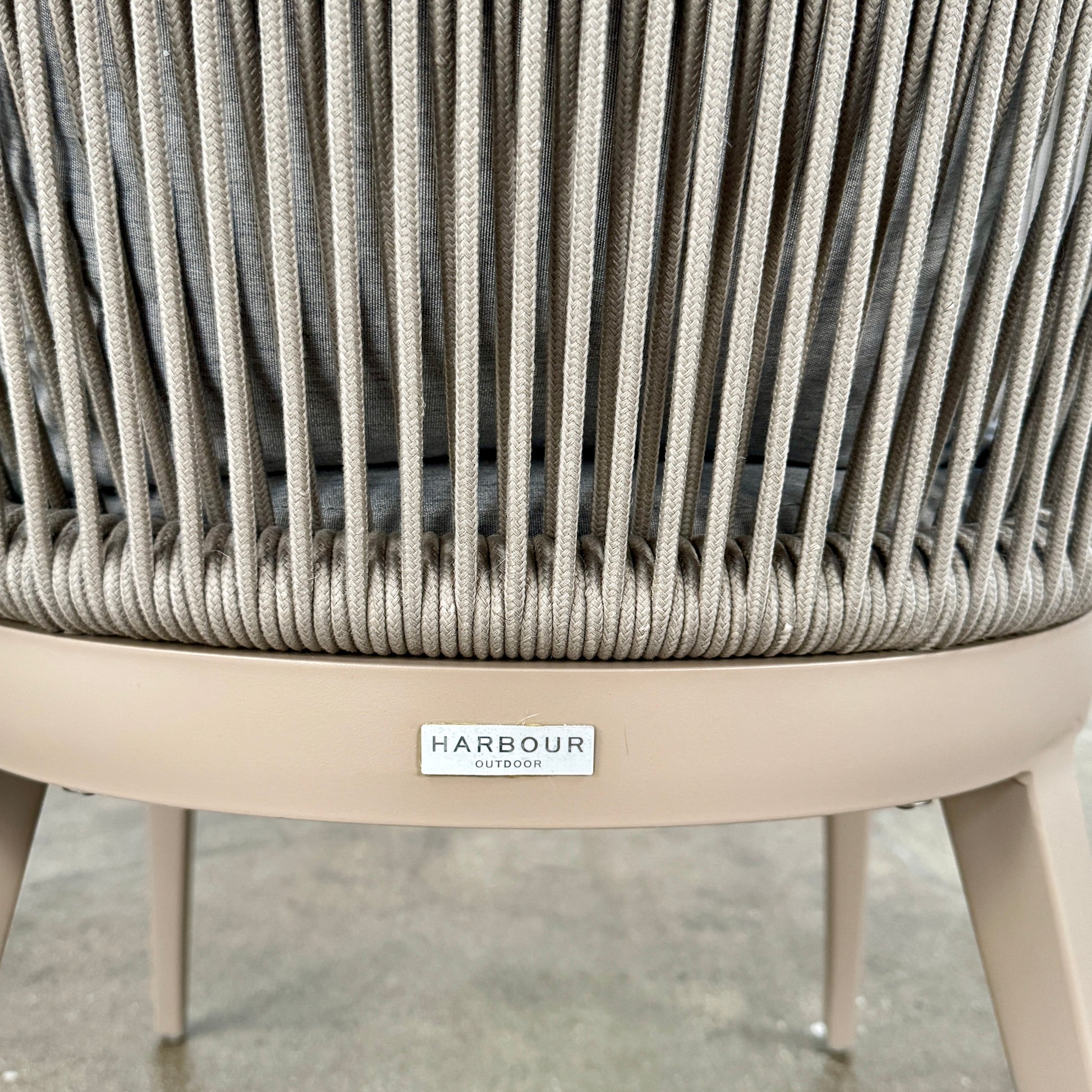 Six Harbour Hamilton Outdoor Dining Chairs by Harbour, featuring a beige woven design with light cushions, are arranged in two rows of three on a plain light background.