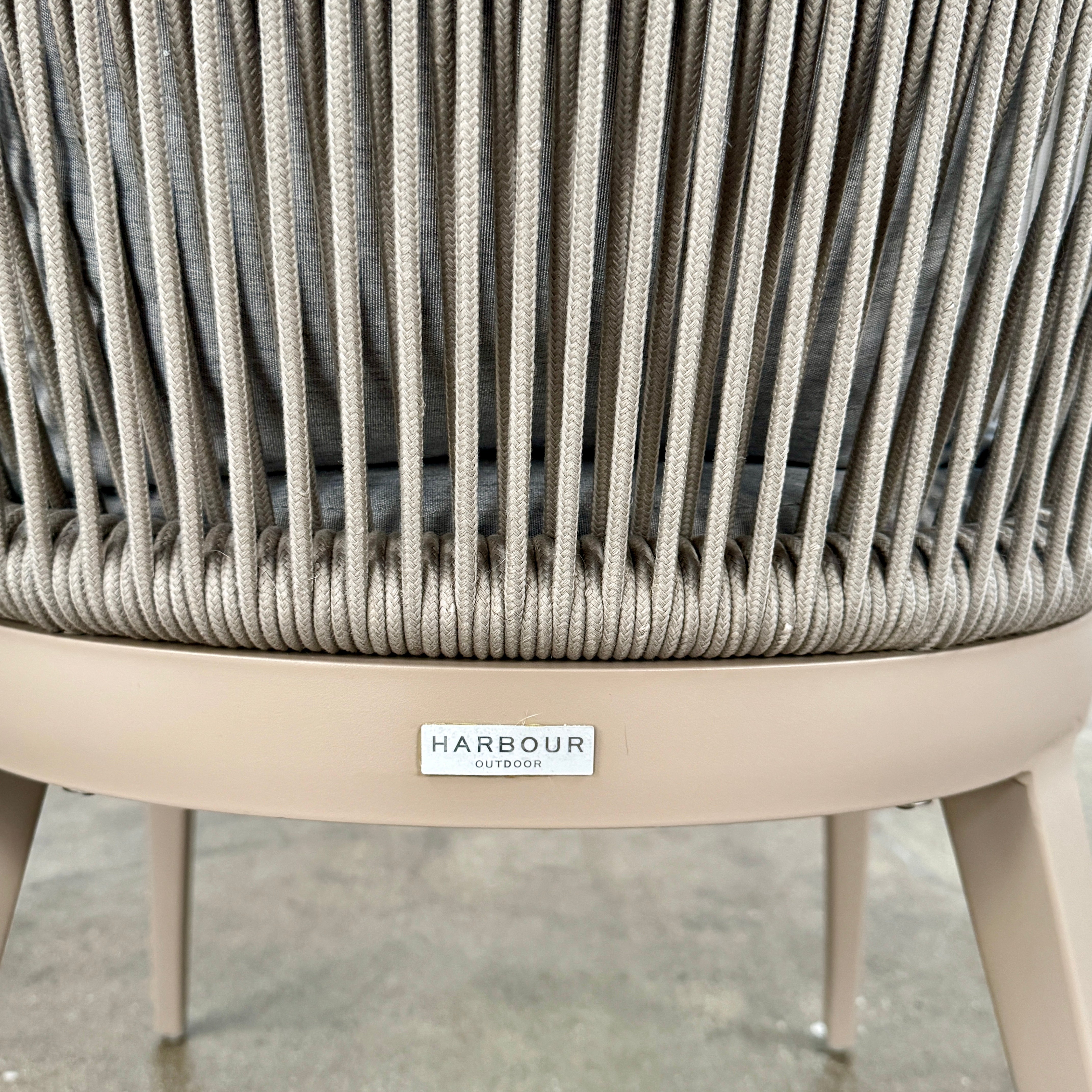 Six Harbour Hamilton Outdoor Dining Chairs by Harbour, featuring a beige woven design with light cushions, are arranged in two rows of three on a plain light background.