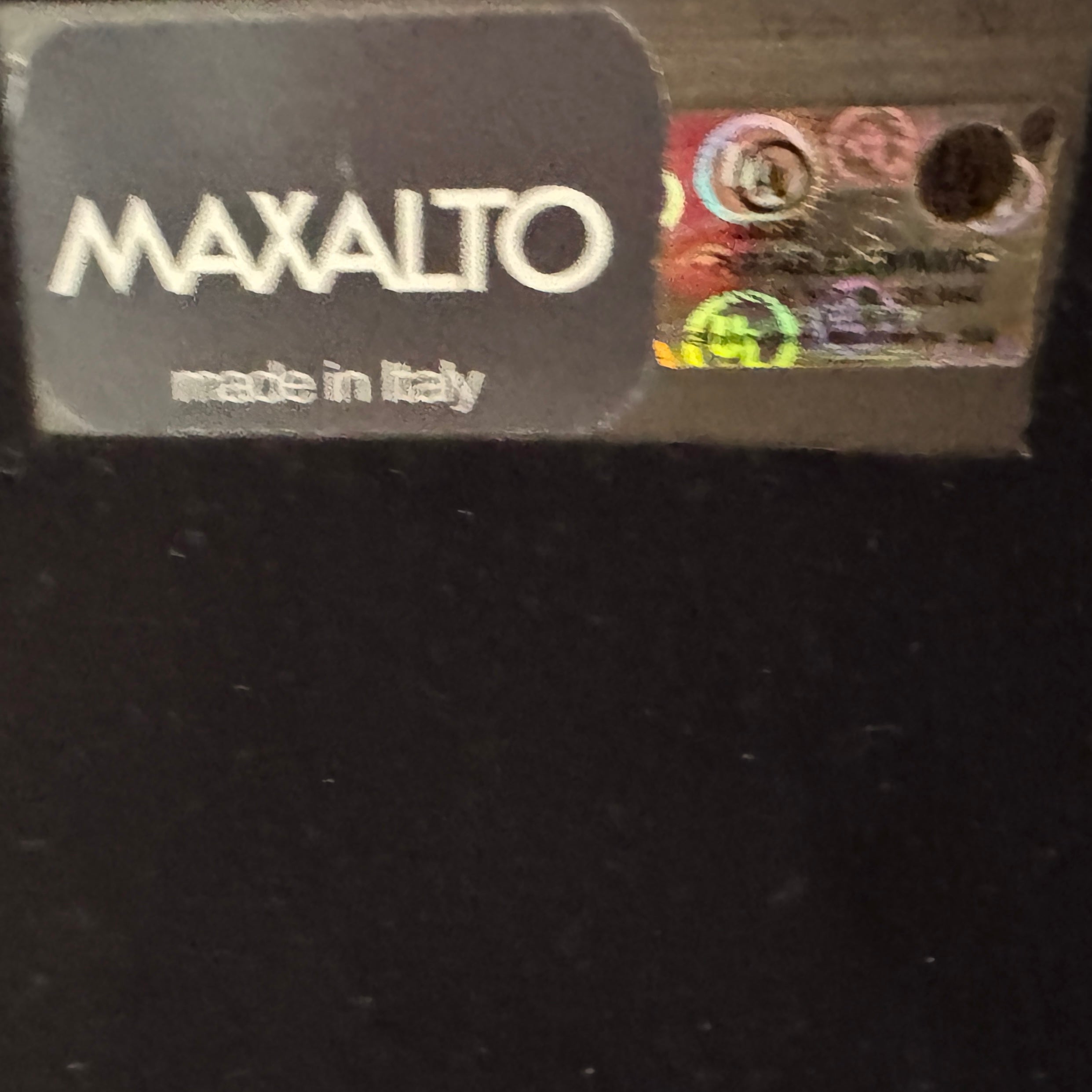 The Maxalto Leukon Table Lamp by Maxalto features a rectangular fabric shade, slim metal stem, and flat base, providing warm, modern lighting.