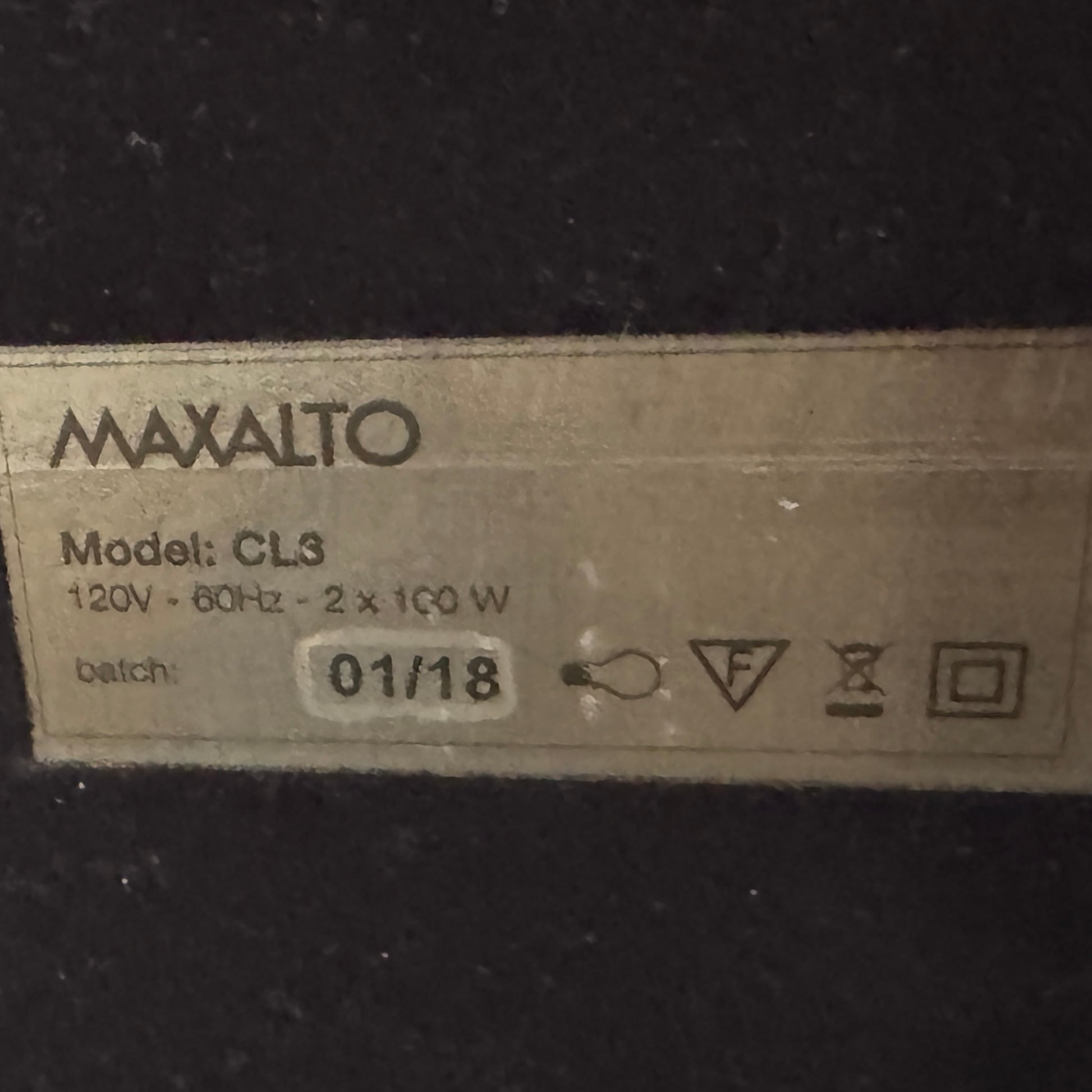 The Maxalto Leukon Table Lamp by Maxalto features a rectangular fabric shade, slim metal stem, and flat base, providing warm, modern lighting.