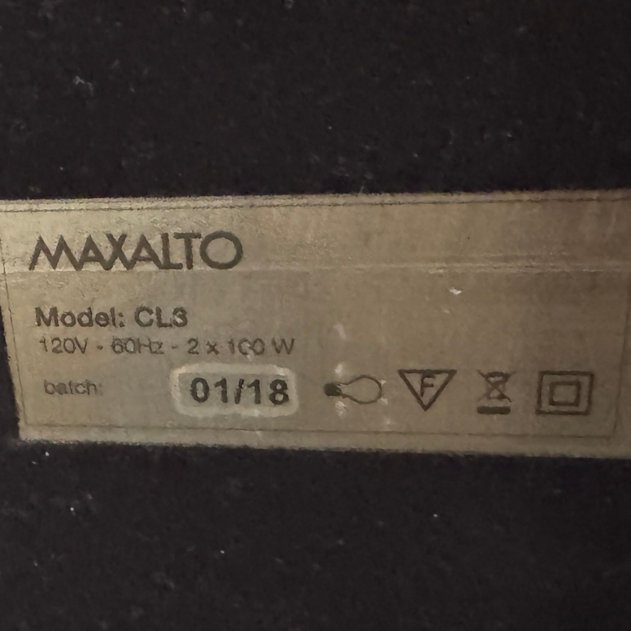 The Maxalto Leukon Table Lamp by Maxalto features a rectangular fabric shade, slim metal stem, and flat base, providing warm, modern lighting.