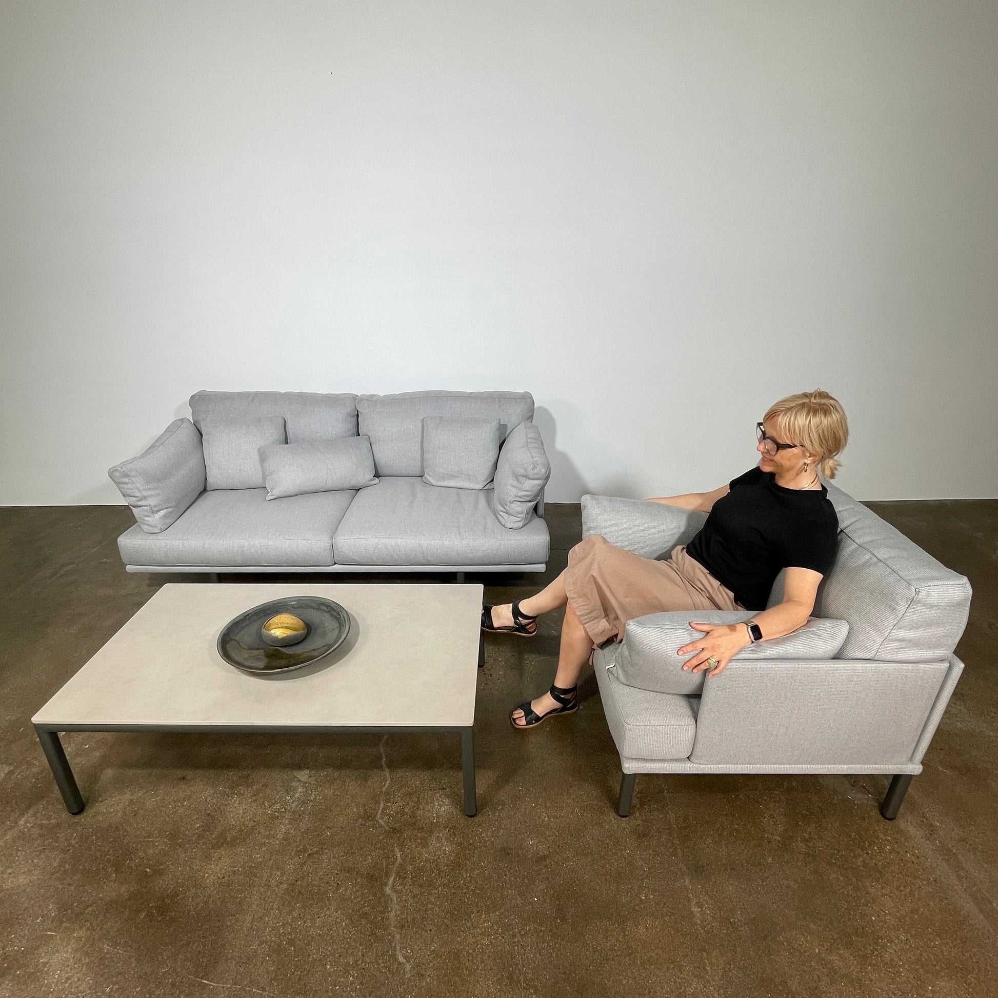 Two light gray sofas from the Point 1920 Long Island Outdoor Seating Set, featuring matching cushions and GOOD SIDE slat suspension, are arranged around a rectangular coffee table on a plain white background.