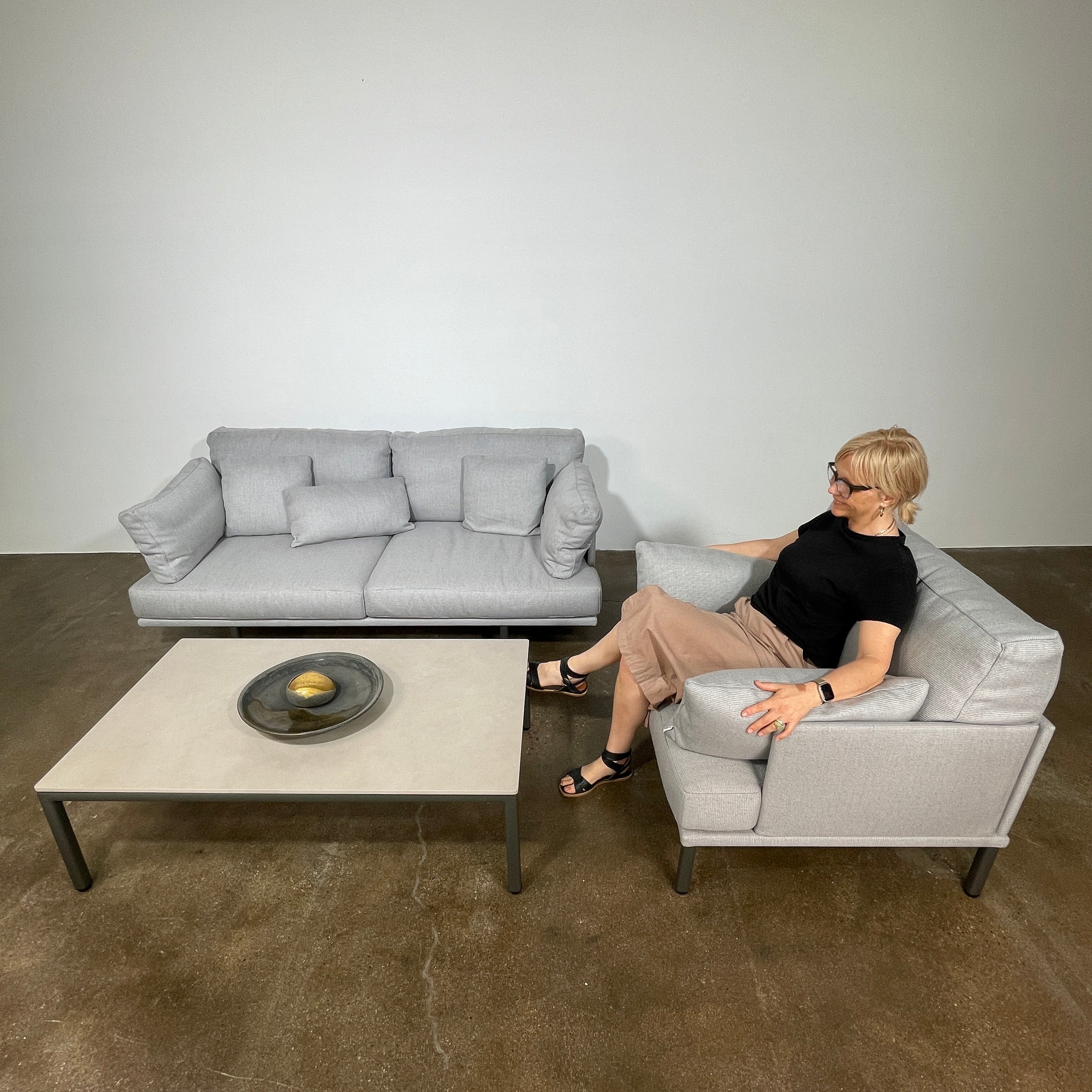 Two light gray sofas from the Point 1920 Long Island Outdoor Seating Set, featuring matching cushions and GOOD SIDE slat suspension, are arranged around a rectangular coffee table on a plain white background.