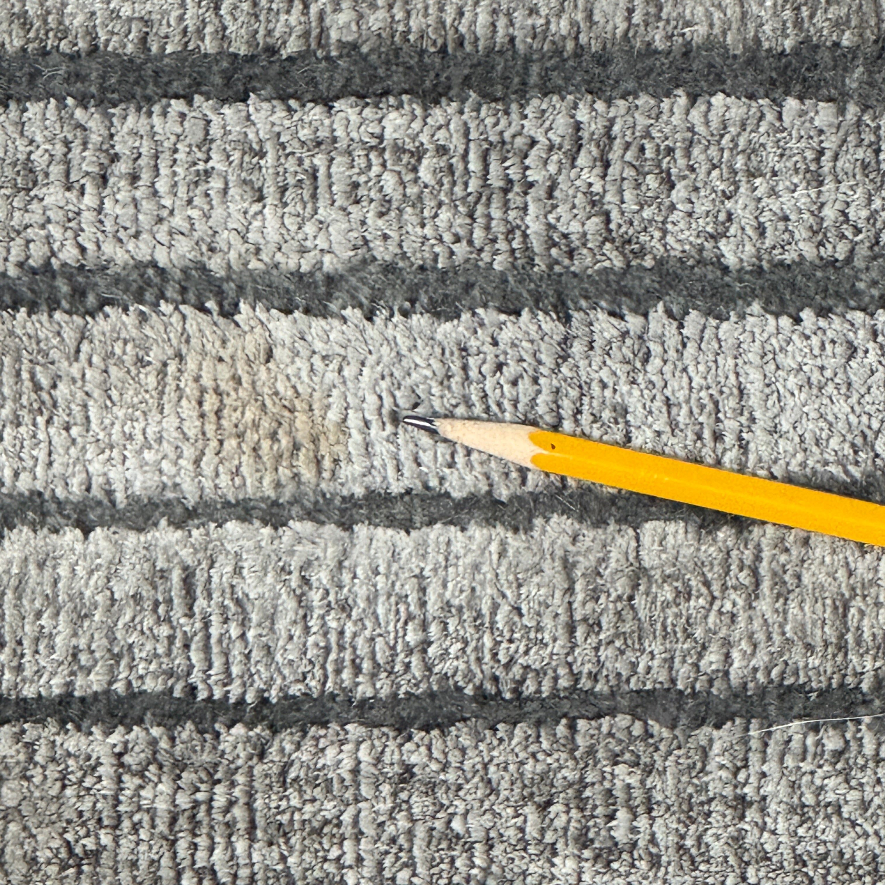 The Delinear Detour Rug 8 x 10 by Delinear features a contemporary rectangular design with a gradient gray pattern and angular geometric lines arranged in a stepped motif.