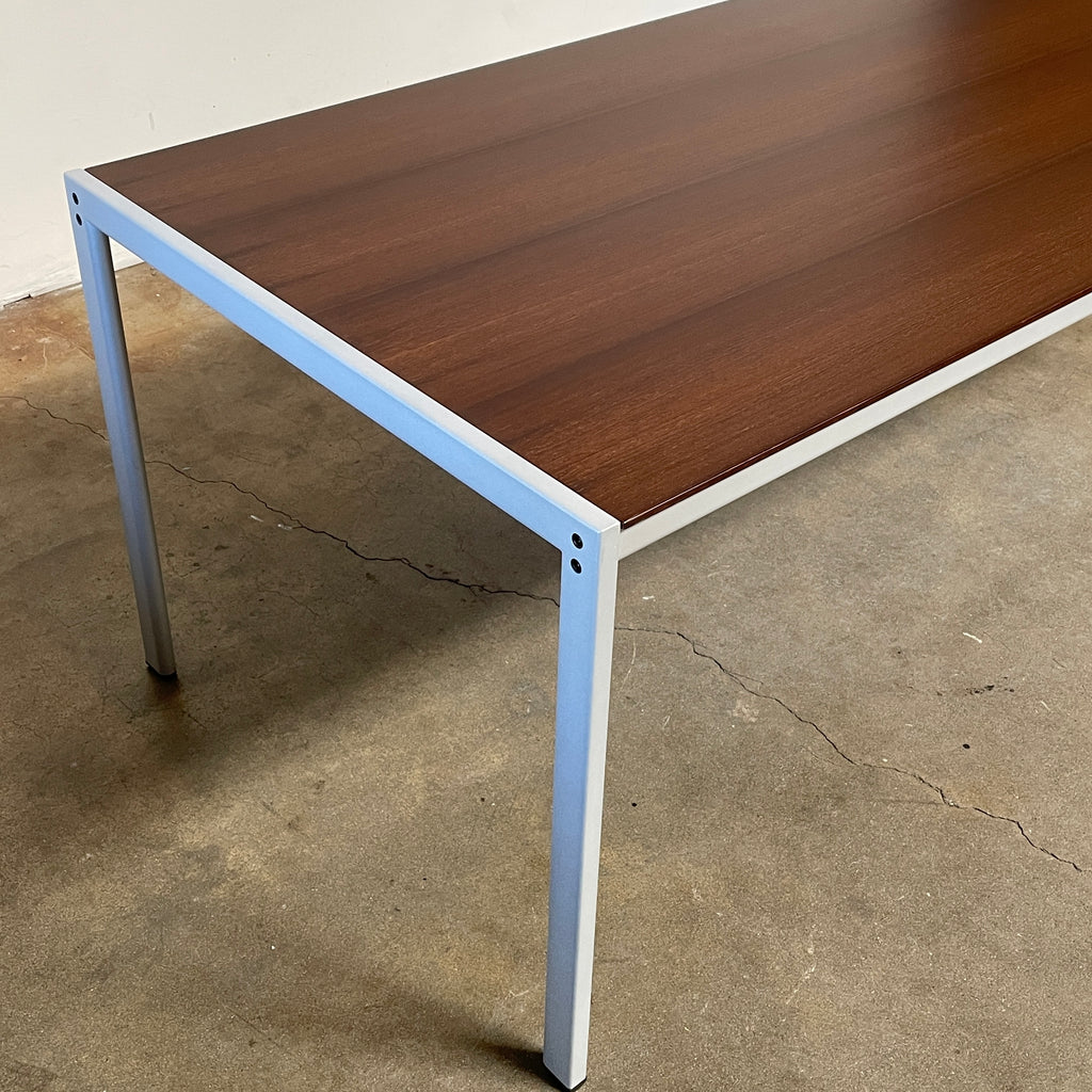 A modern dining table with a metal frame and a white top, reminiscent of Zanotta's design aesthetic, like the Zanotta SanMarco 2570 Dining Table.