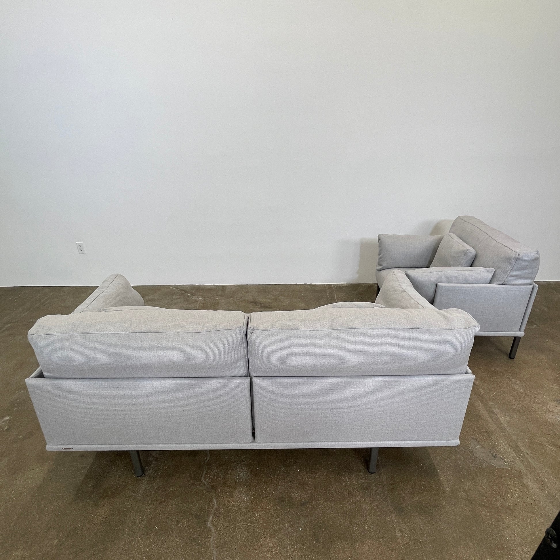 Two light gray sofas from the Point 1920 Long Island Outdoor Seating Set, featuring matching cushions and GOOD SIDE slat suspension, are arranged around a rectangular coffee table on a plain white background.
