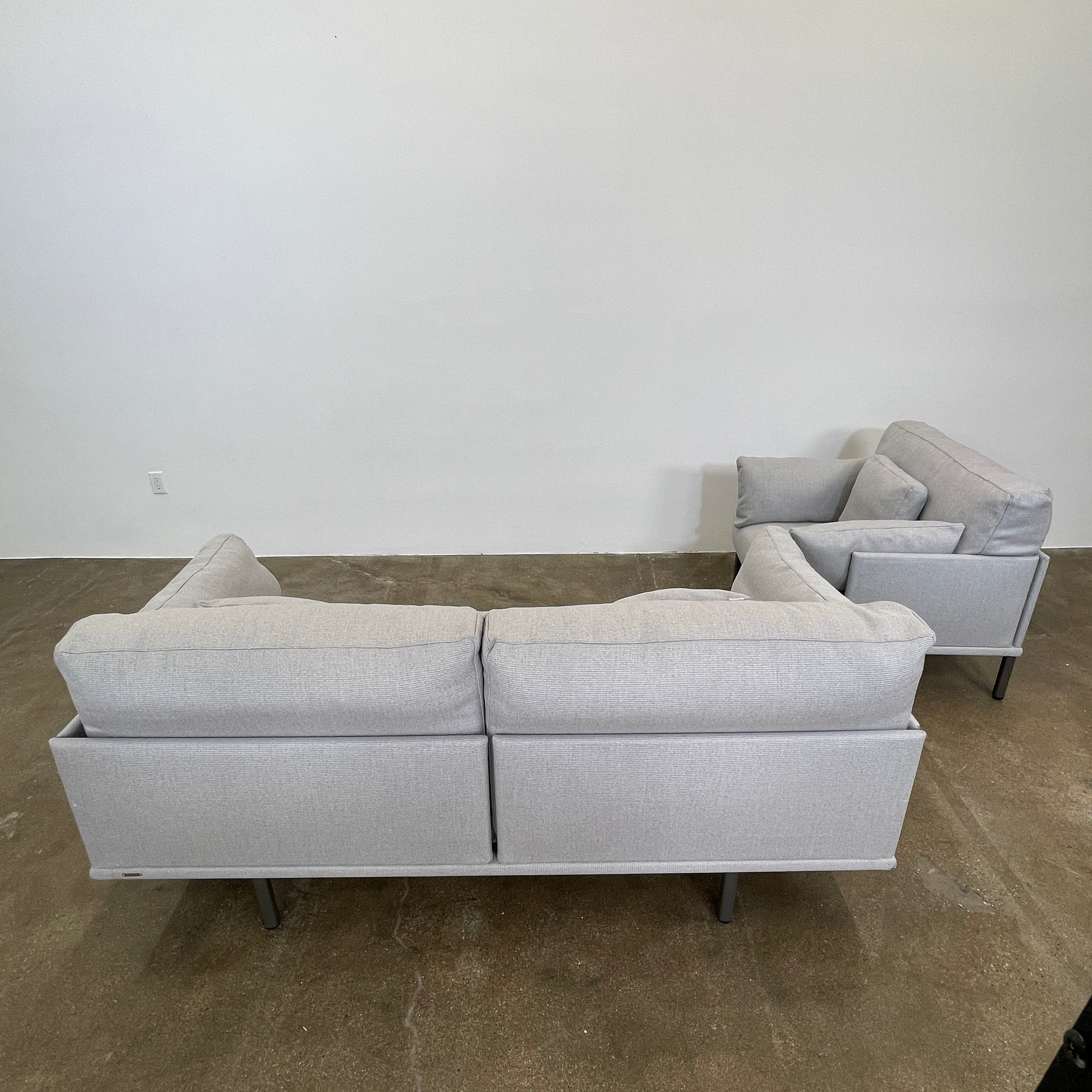 Two light gray sofas from the Point 1920 Long Island Outdoor Seating Set, featuring matching cushions and GOOD SIDE slat suspension, are arranged around a rectangular coffee table on a plain white background.