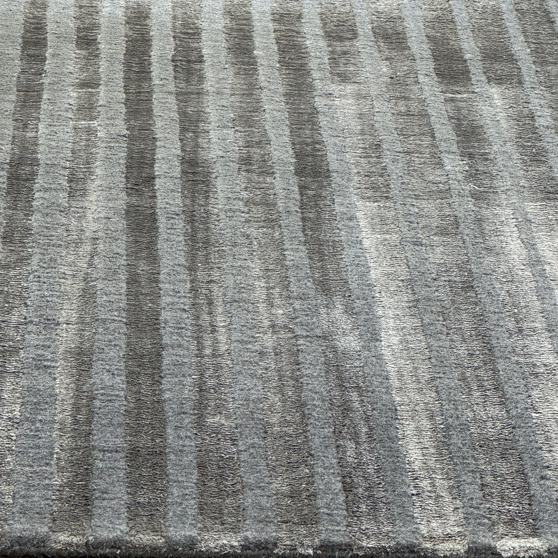 The Delinear Detour Rug 8 x 10 by Delinear features a contemporary rectangular design with a gradient gray pattern and angular geometric lines arranged in a stepped motif.