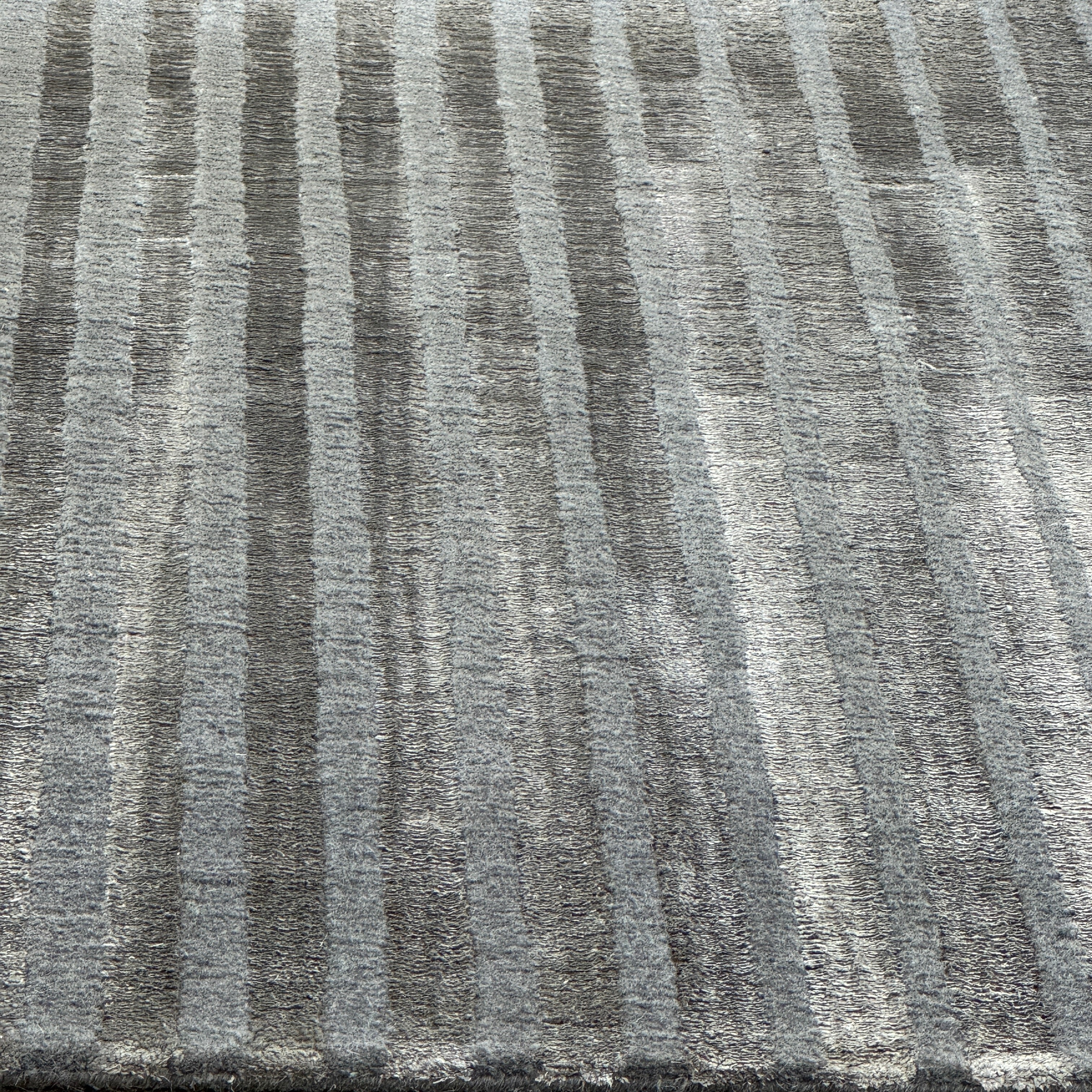 The Delinear Detour Rug 8 x 10 by Delinear features a contemporary rectangular design with a gradient gray pattern and angular geometric lines arranged in a stepped motif.