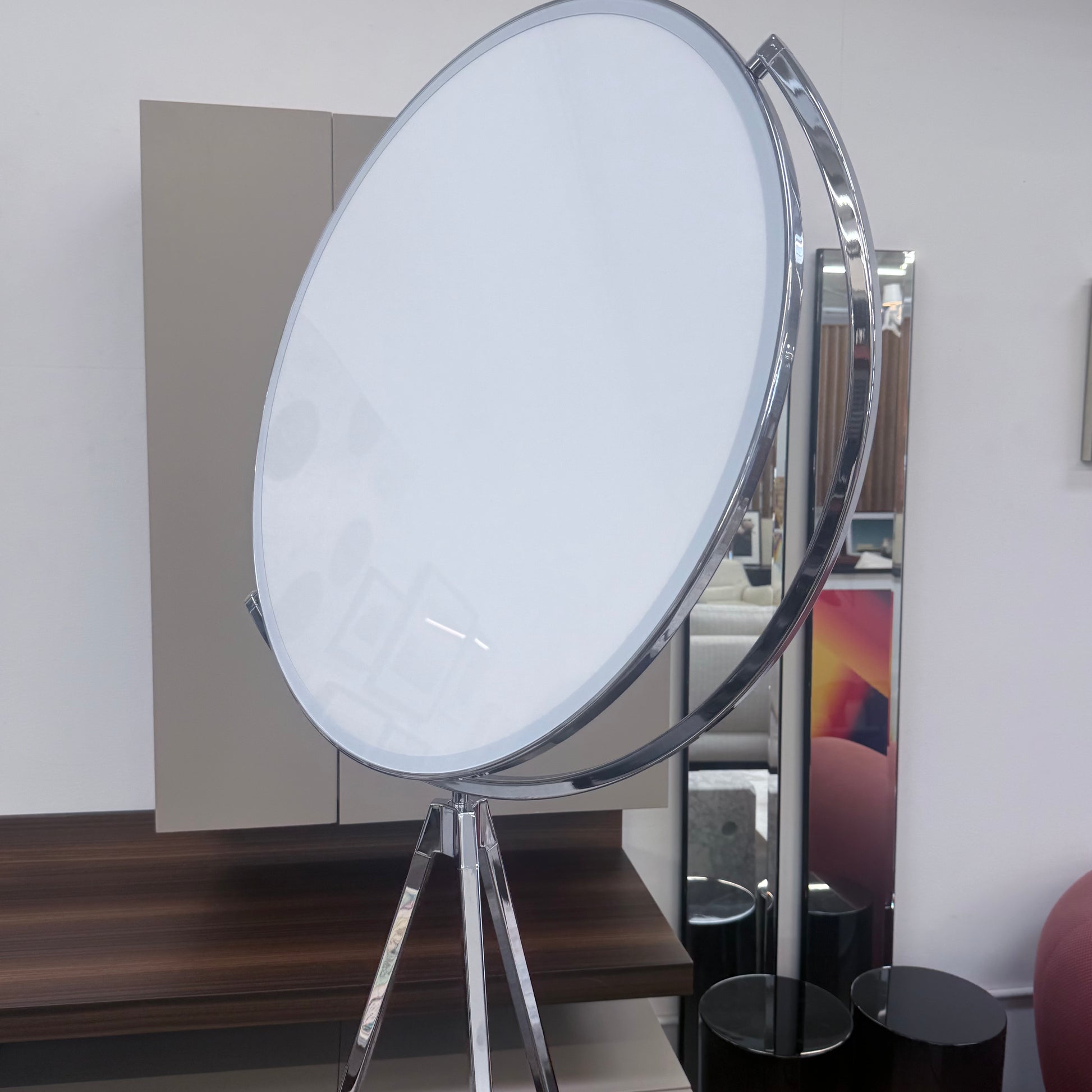 The Flos Superloon Floor Lamp by Flos features a round light on a three-legged chrome stand with a modern tripod design, set against a plain light background.