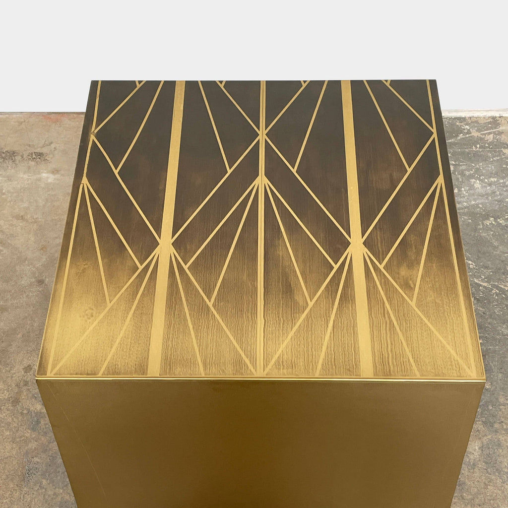 A TrackDesign Aestus Brass Side Table with a geometric design.