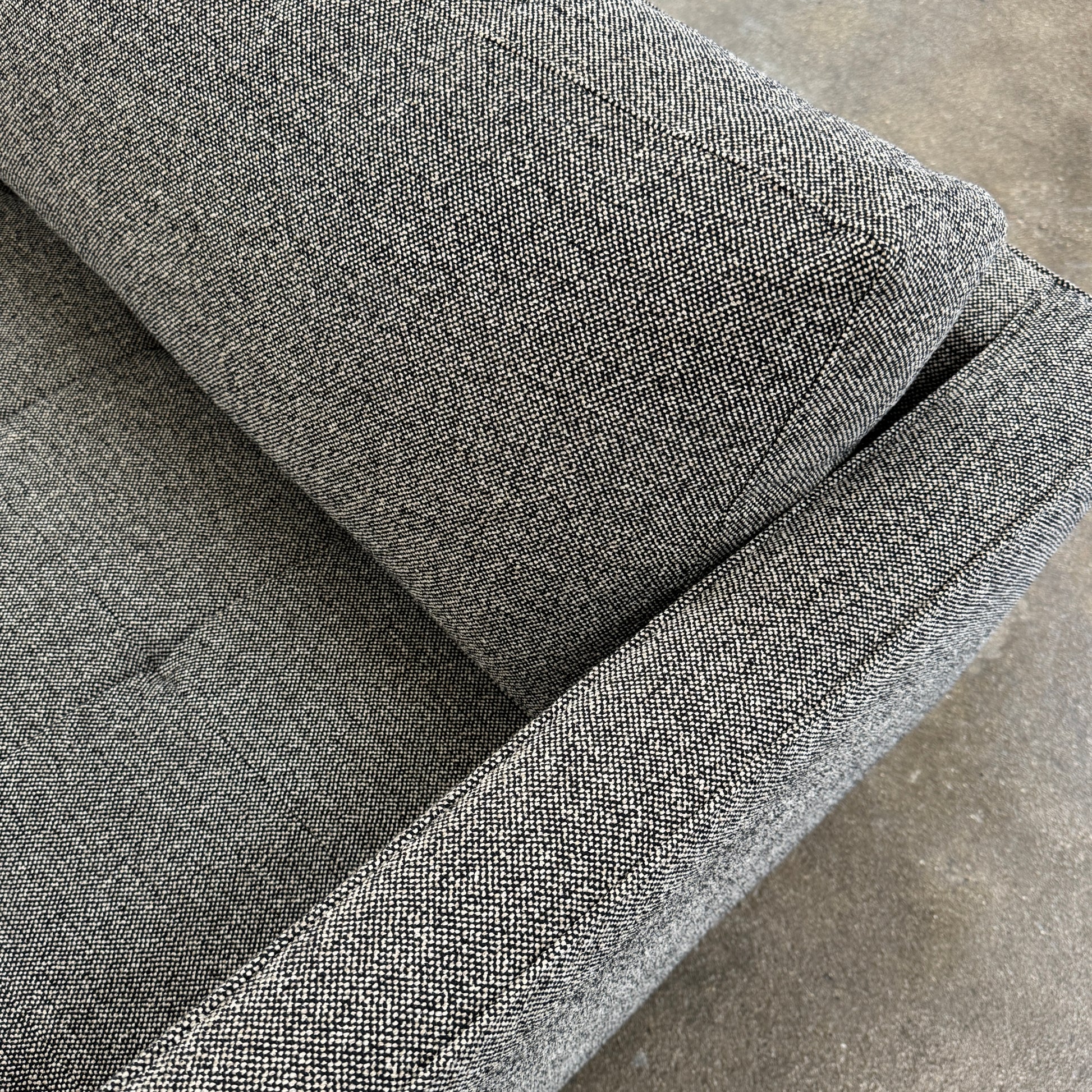 The Blu Dot Paramont Sofa is a grey, three-seater sofa by Blu Dot, featuring metal legs and two back cushions, shown against a plain white background.