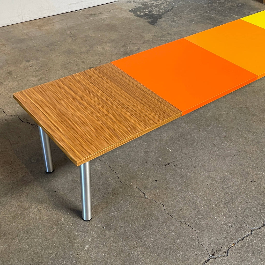 A Mazzei Multi-Panel Table with a contemporary design featuring yellow, orange, and blue stripes.