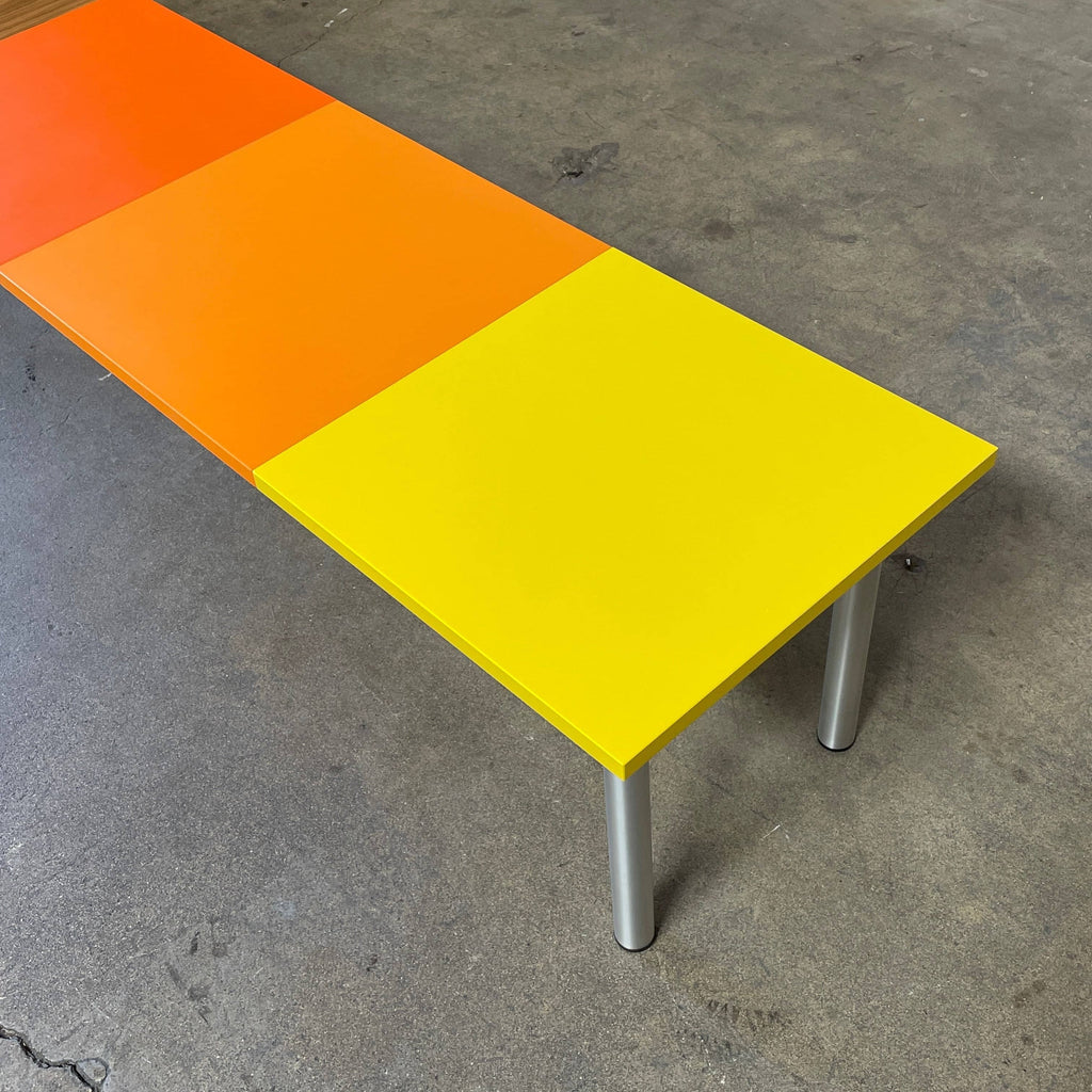 A Mazzei Multi-Panel Table with a contemporary design featuring yellow, orange, and blue stripes.