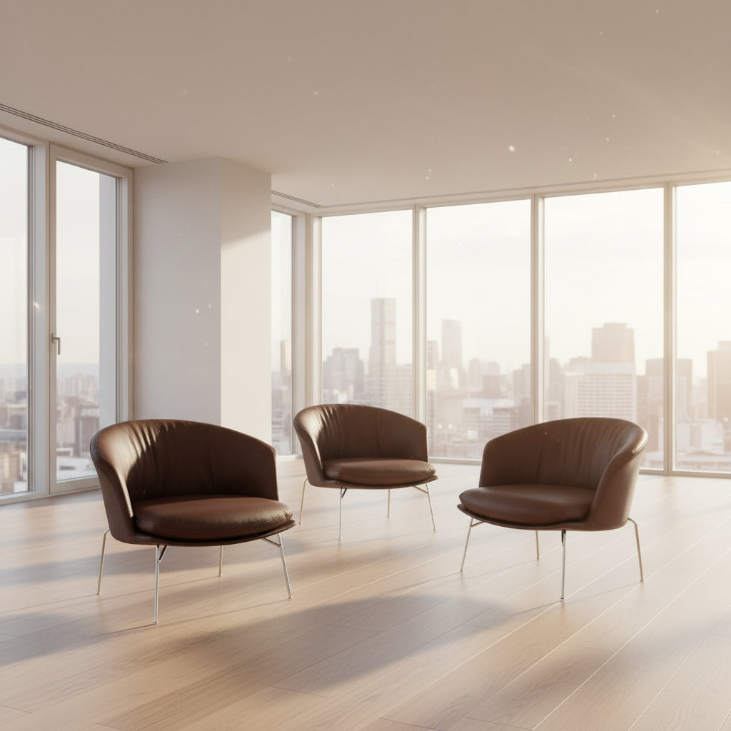 The Driade Moon Lounge Chair by Driade features a modern brown leather design, curved backrest, and slim metal legs, shown against a plain white background.