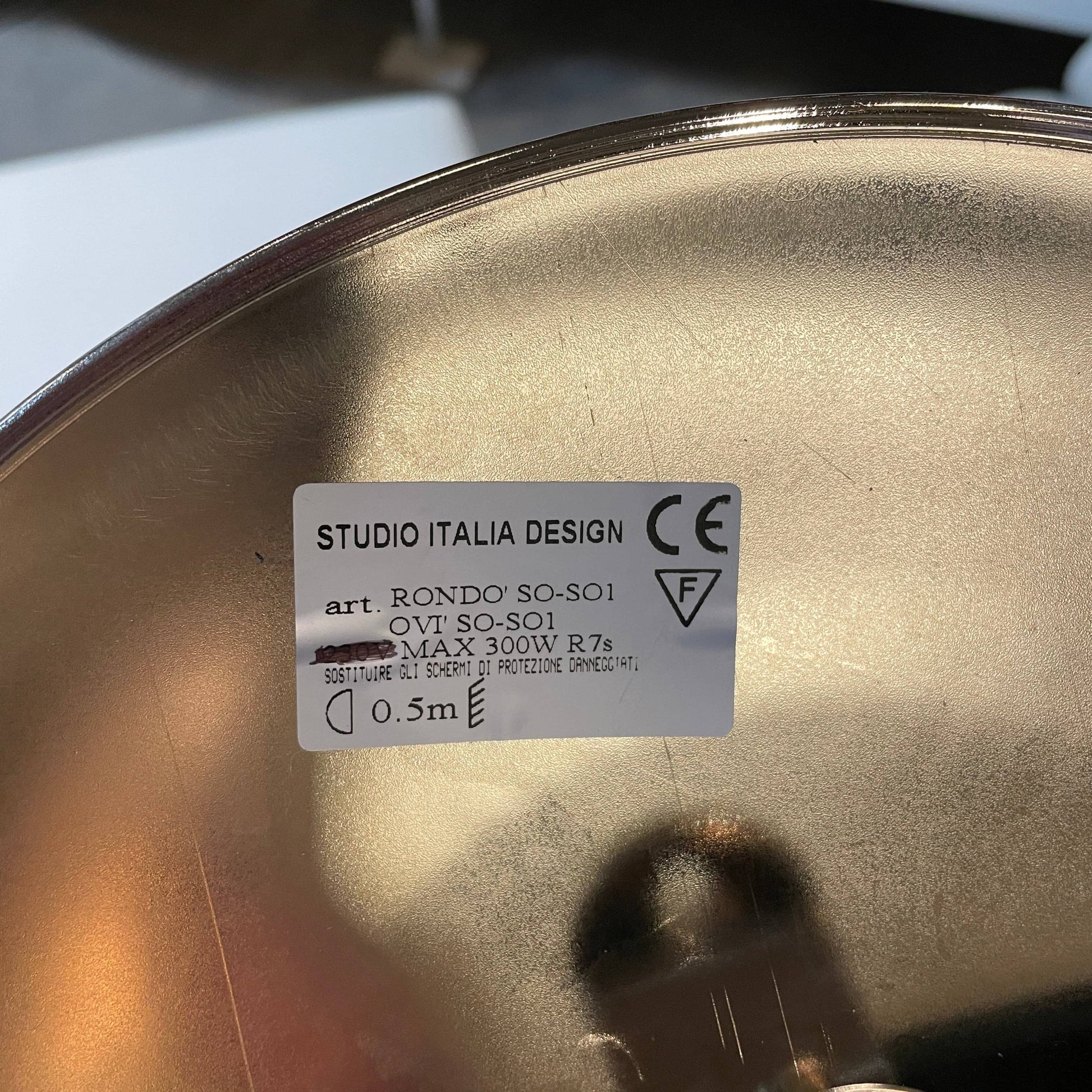 Modern pendant light with a minimalist design, suspended from a metallic base by two cables, the Studio Design Italia Rondo SO Ceiling Light.