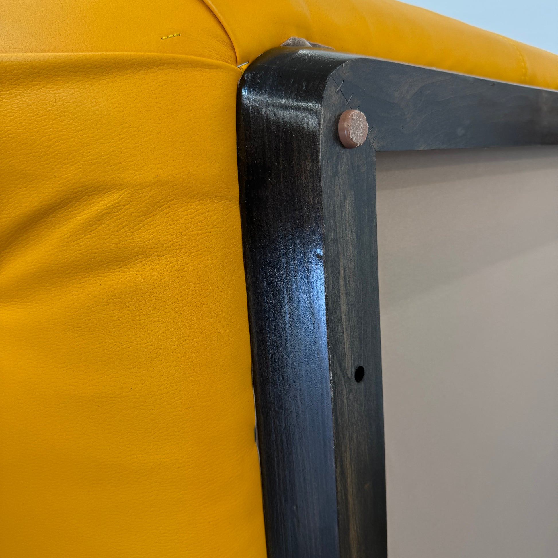 Yellow rectangular Tufted Leather Ottoman with rounded edges and a flat black base, ideal for extra seating, displayed on a plain white background. Brand: Unknown.