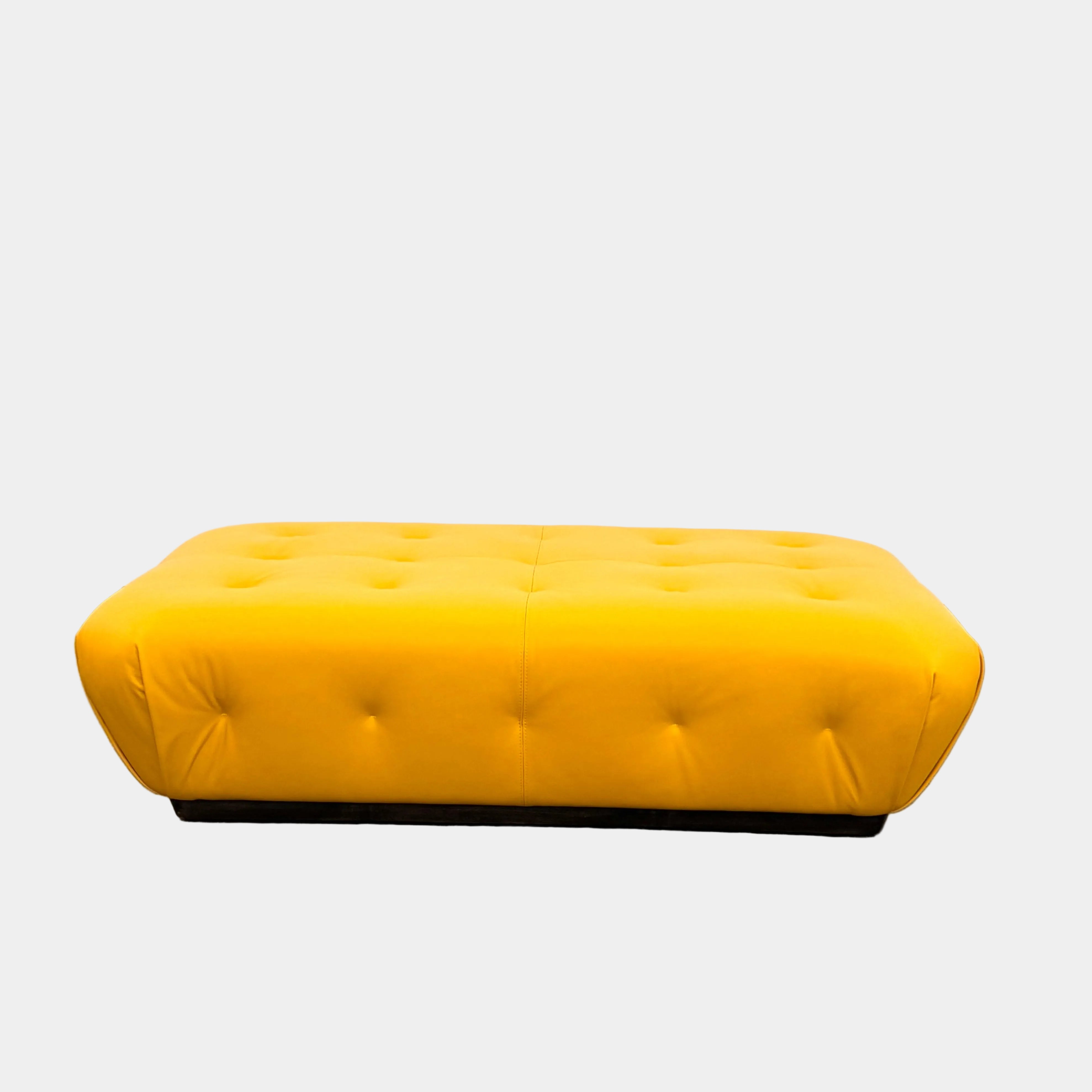 The Tufted Leather Ottoman by Modern Resale features a rectangular yellow tufted leather design with smooth, rounded edges, ideal as a stylish footrest or extra seating, shown on a plain white background.