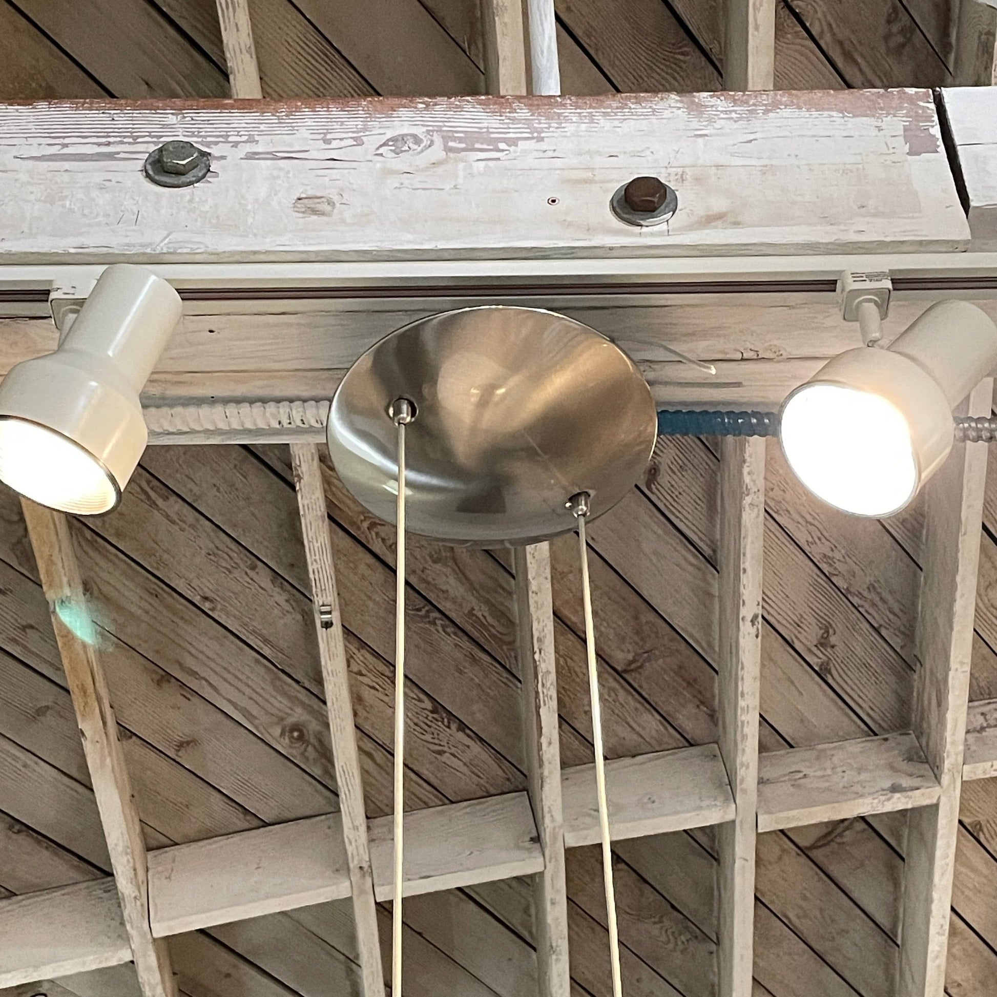 Modern pendant light with a minimalist design, suspended from a metallic base by two cables, the Studio Design Italia Rondo SO Ceiling Light.