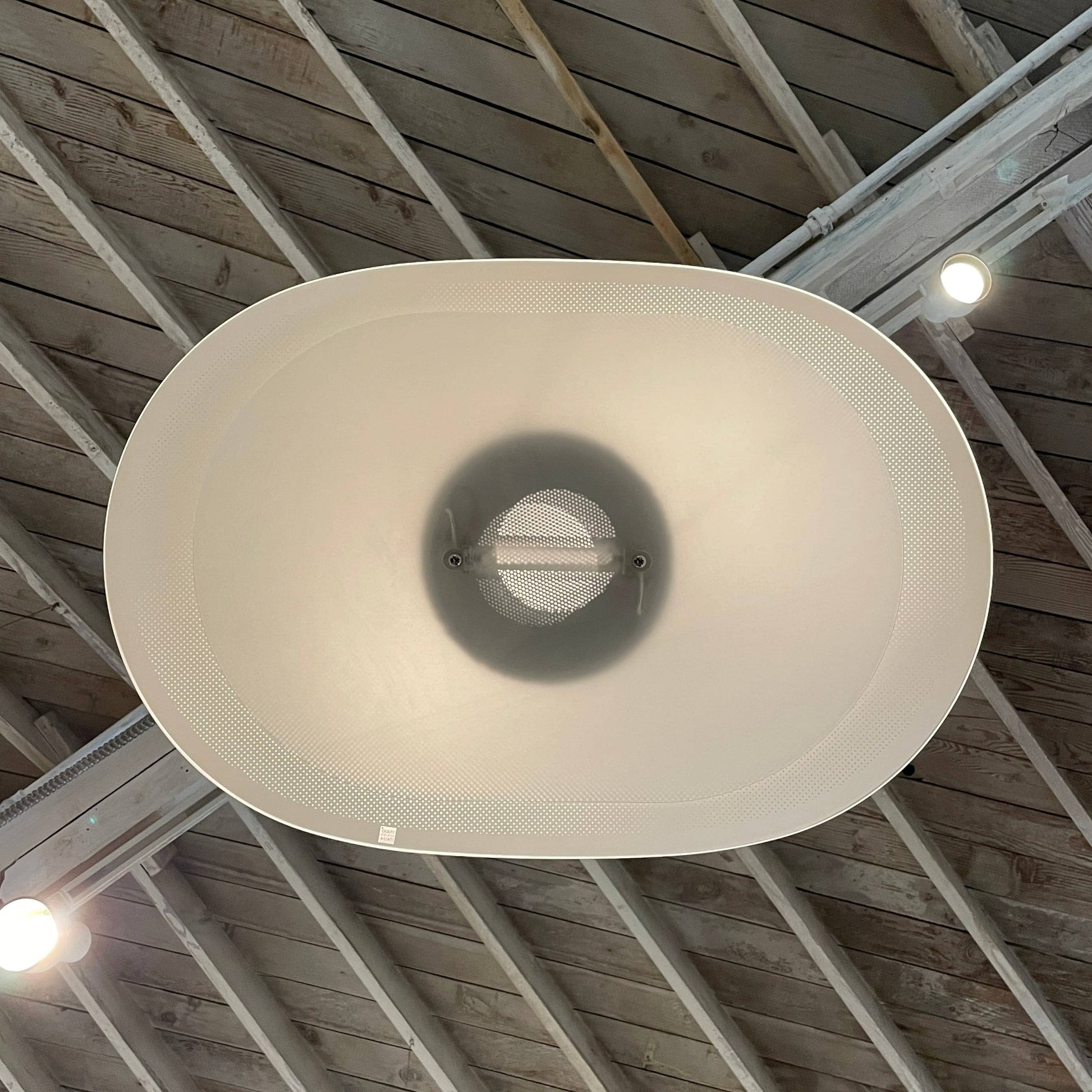 Modern pendant light with a minimalist design, suspended from a metallic base by two cables, the Studio Design Italia Rondo SO Ceiling Light.