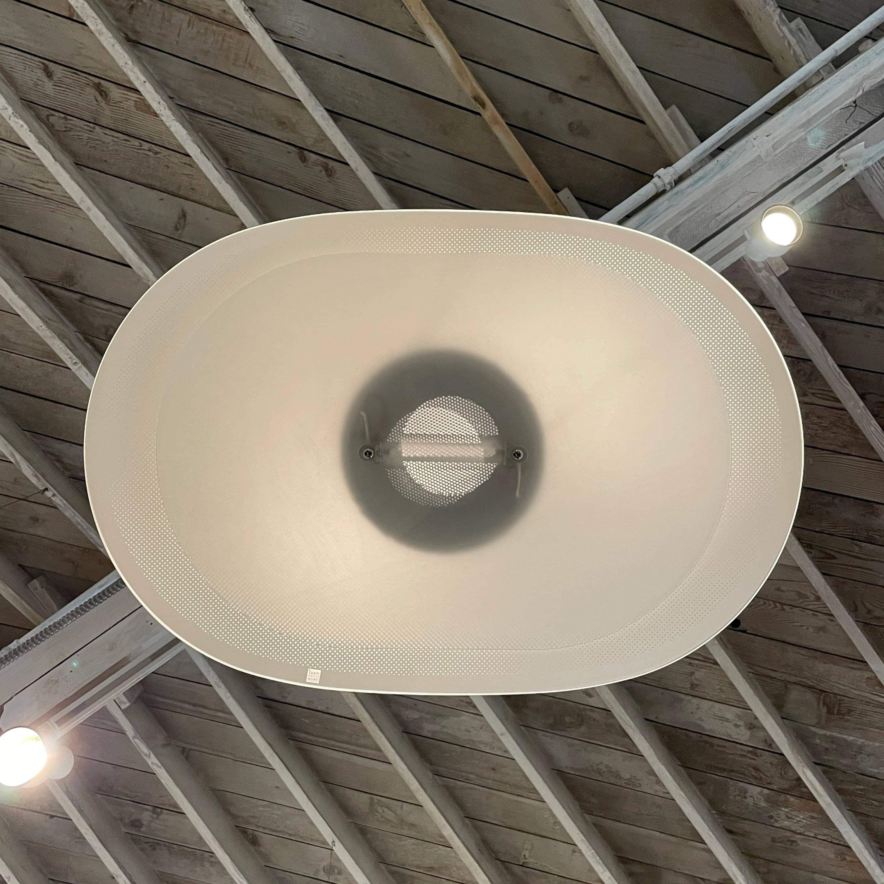 Modern pendant light with a minimalist design, suspended from a metallic base by two cables, the Studio Design Italia Rondo SO Ceiling Light.