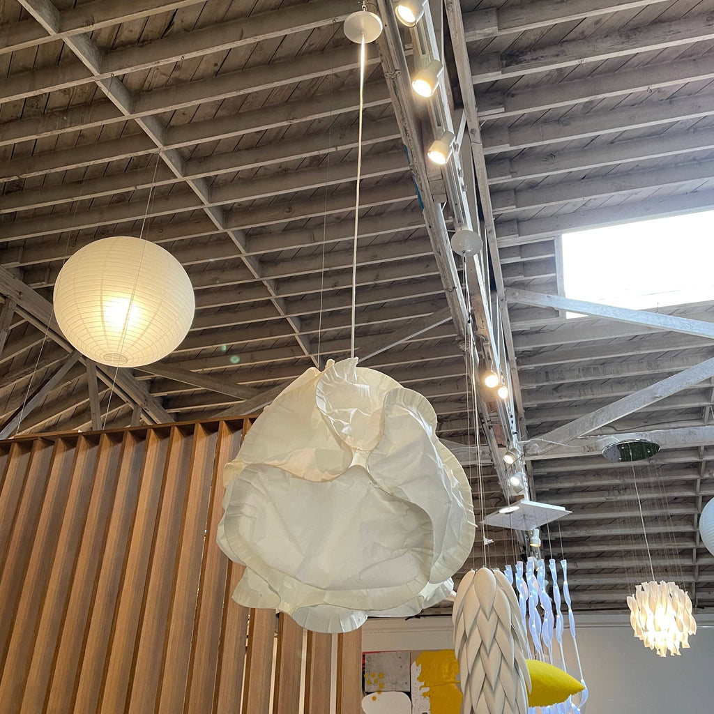 A room with several white Belux Cloud Ceiling Lights hanging from the ceiling.