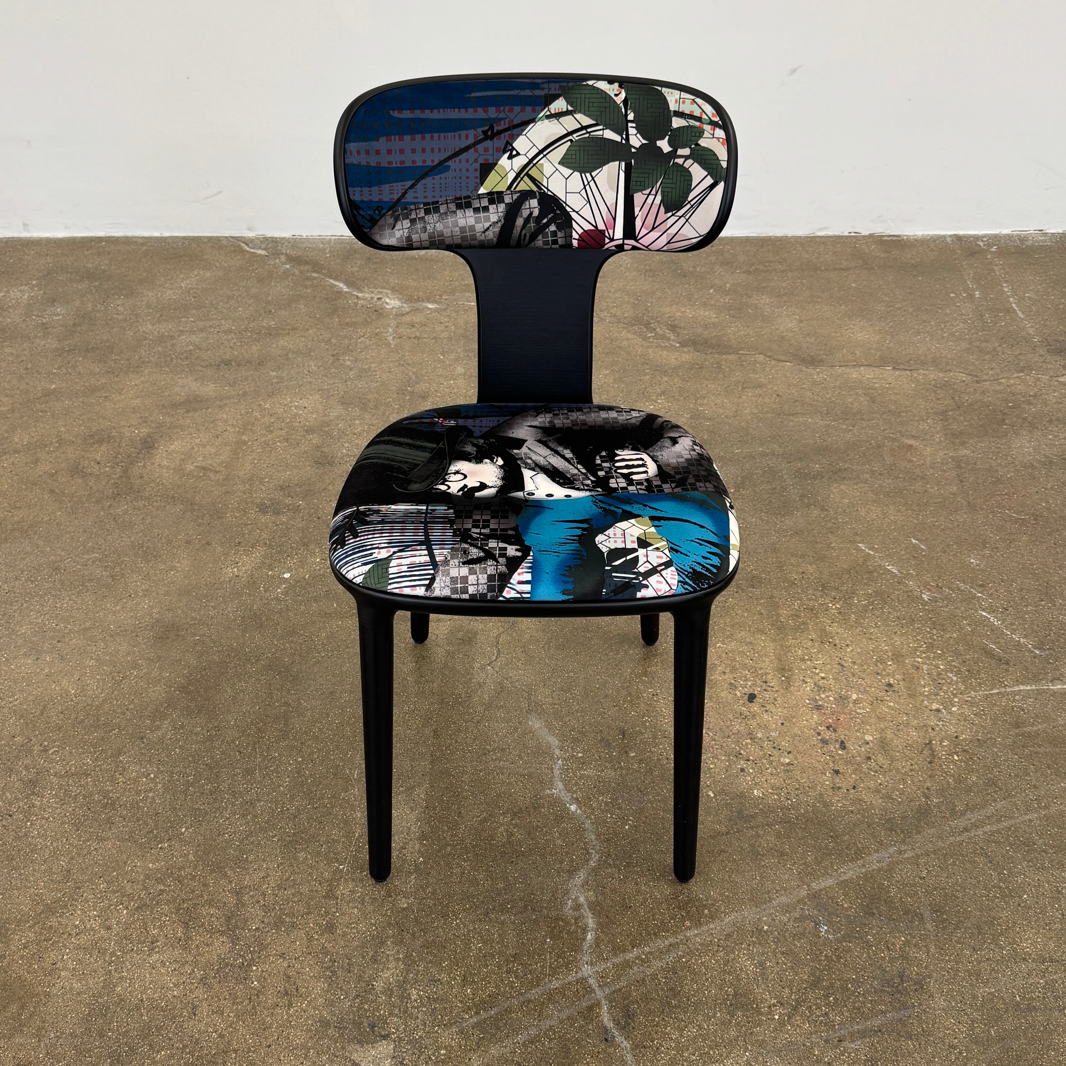 A set of six black Roche Bobois Globe Trotter Operette dining chairs, featuring patterned cushions and backs, arranged in two rows against a plain white background.