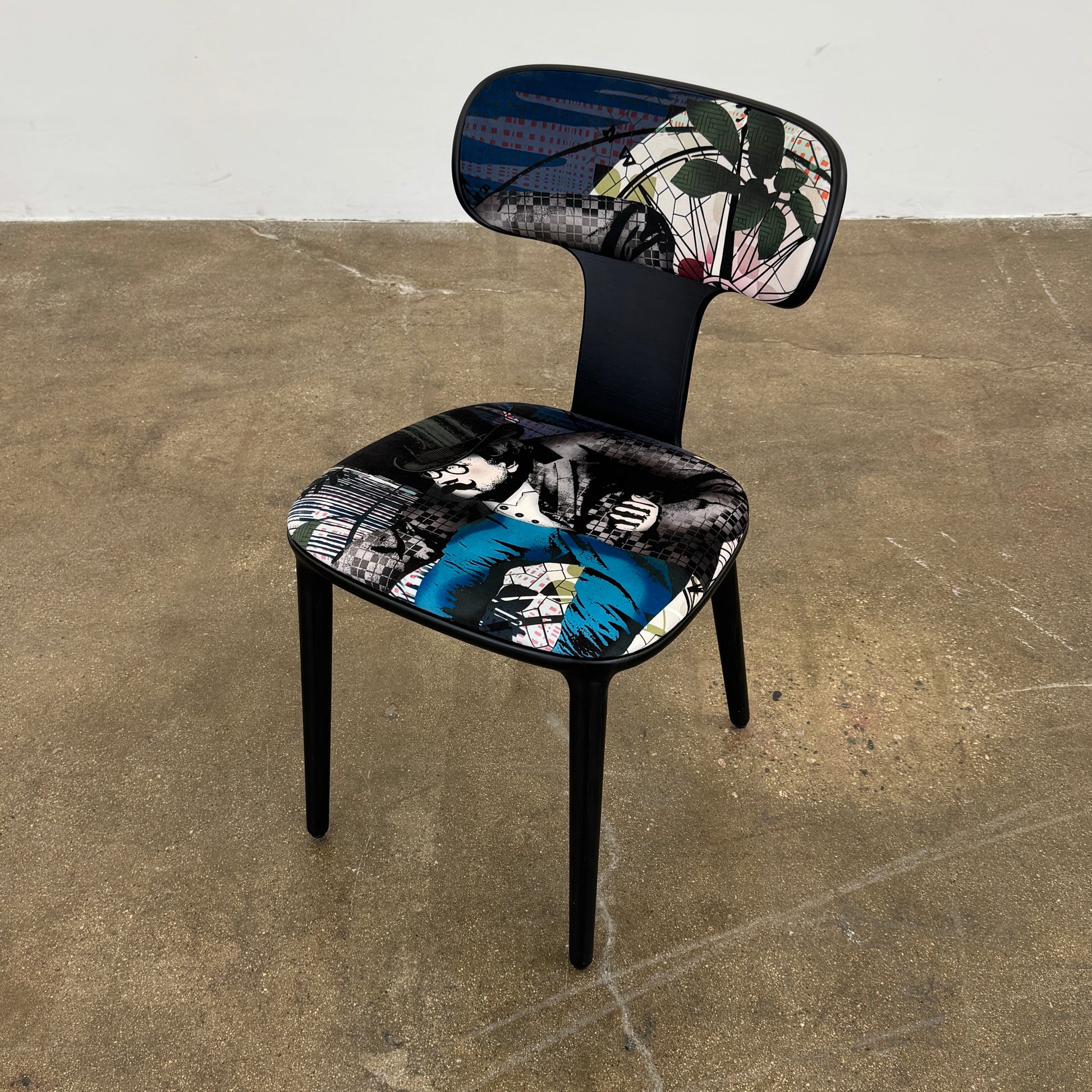 A set of six black Roche Bobois Globe Trotter Operette dining chairs, featuring patterned cushions and backs, arranged in two rows against a plain white background.