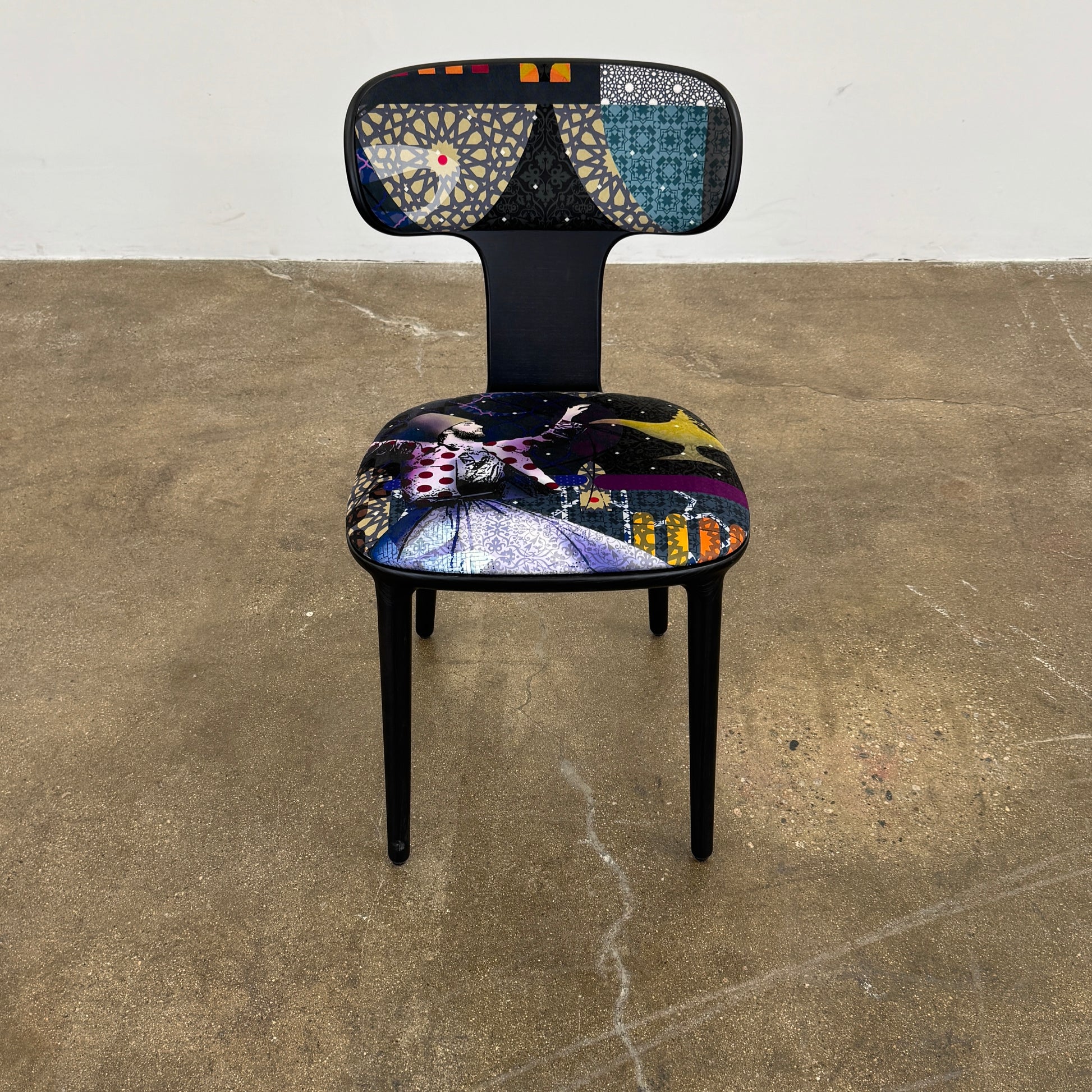 A set of six black Roche Bobois Globe Trotter Operette dining chairs, featuring patterned cushions and backs, arranged in two rows against a plain white background.