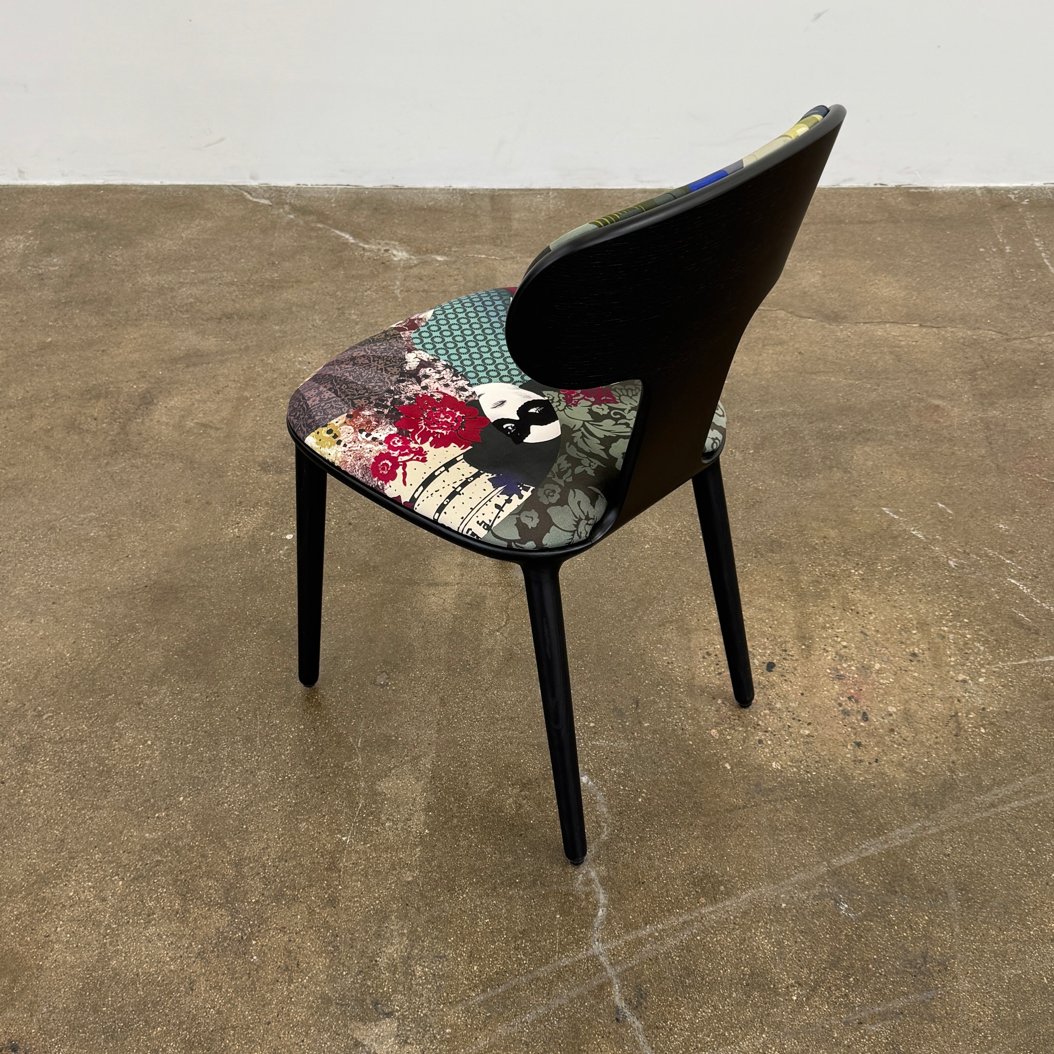 A set of six black Roche Bobois Globe Trotter Operette dining chairs, featuring patterned cushions and backs, arranged in two rows against a plain white background.